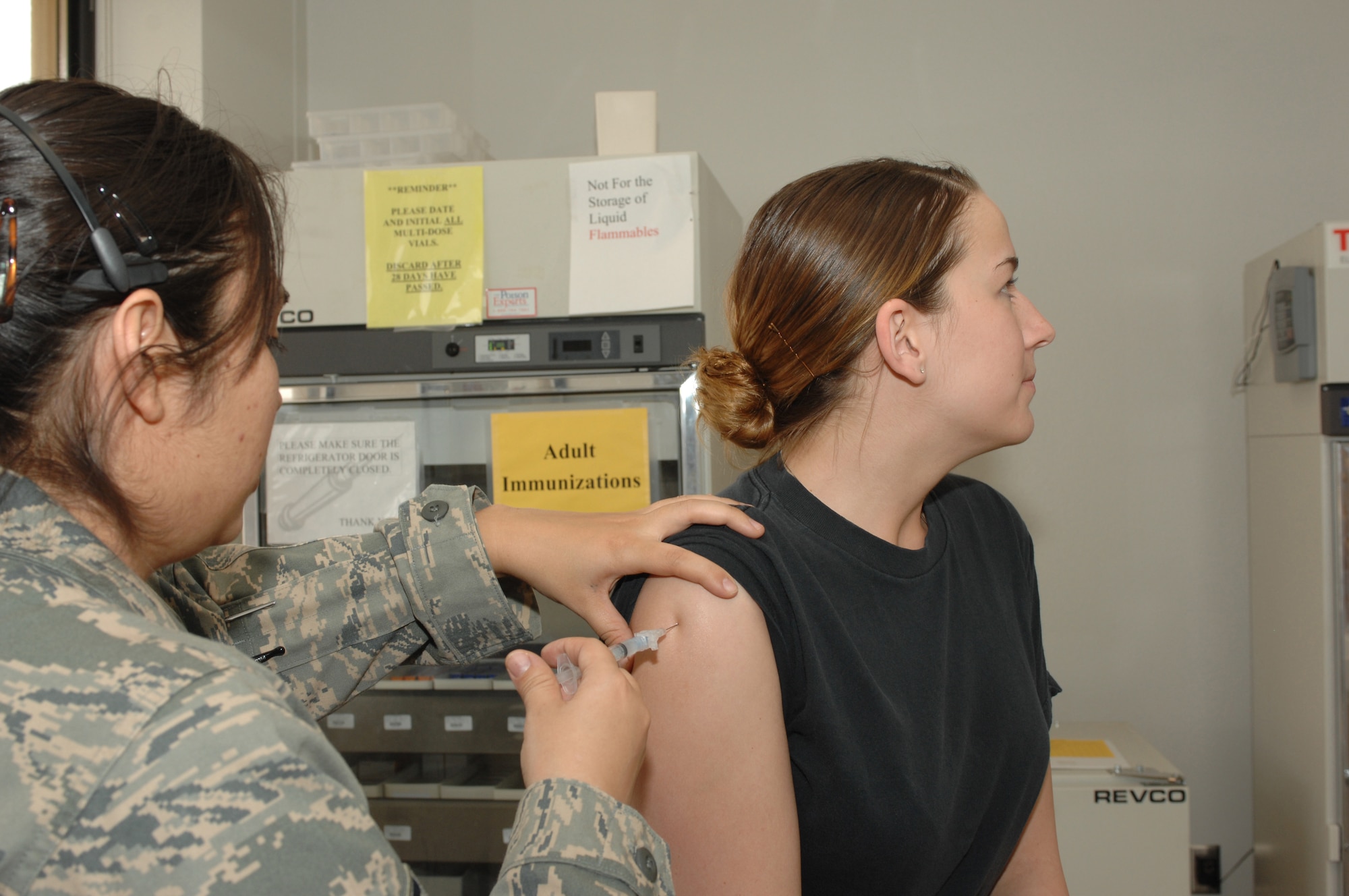 DYESS AIR FORCE BASE, Texas -- Airman 1st Class Jennifer Romig, 7th BW/PA, receives a vaccination from Staff Sgt Melinda Grisby, Alllery/Immunization technician, at the 7th Medical Group, March 10. Dyess Airman must stay current on their vaccination to maintain deployment readiness. (U.S Air Force photo by Senior Airman Courtney Richardson)