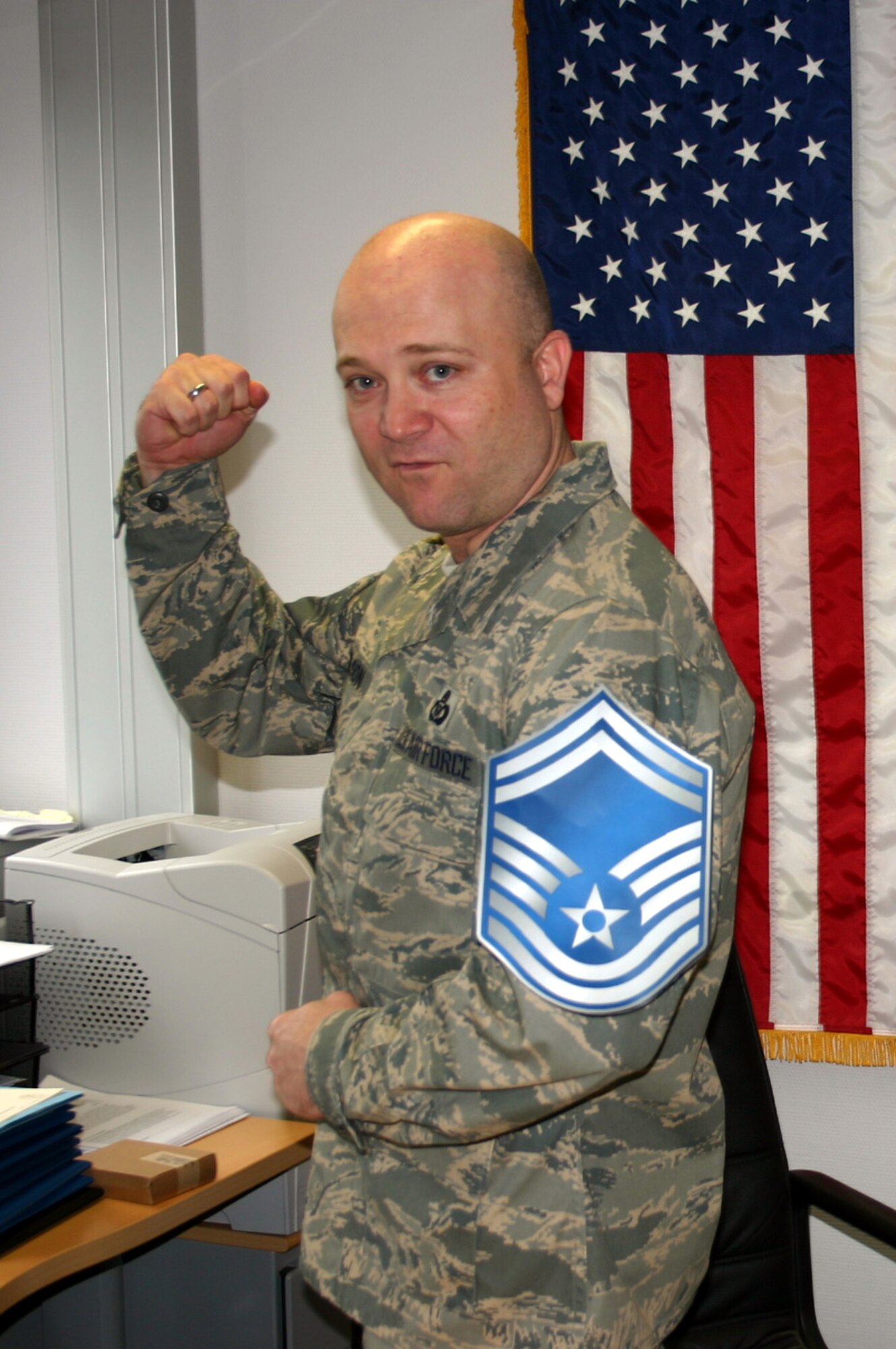 SPANGDAHLEM AIR BASE, Germany -- Richard Wilson senior master sergeant stripes tacked on by Capt. Artis Poe after being notified that he had been selected for promotion. Both Airmen are assigned to the 606th Air Control Squadron March 12, 2008. (U.S. Air Force photo/Staff Sgt. Daniel Heise)