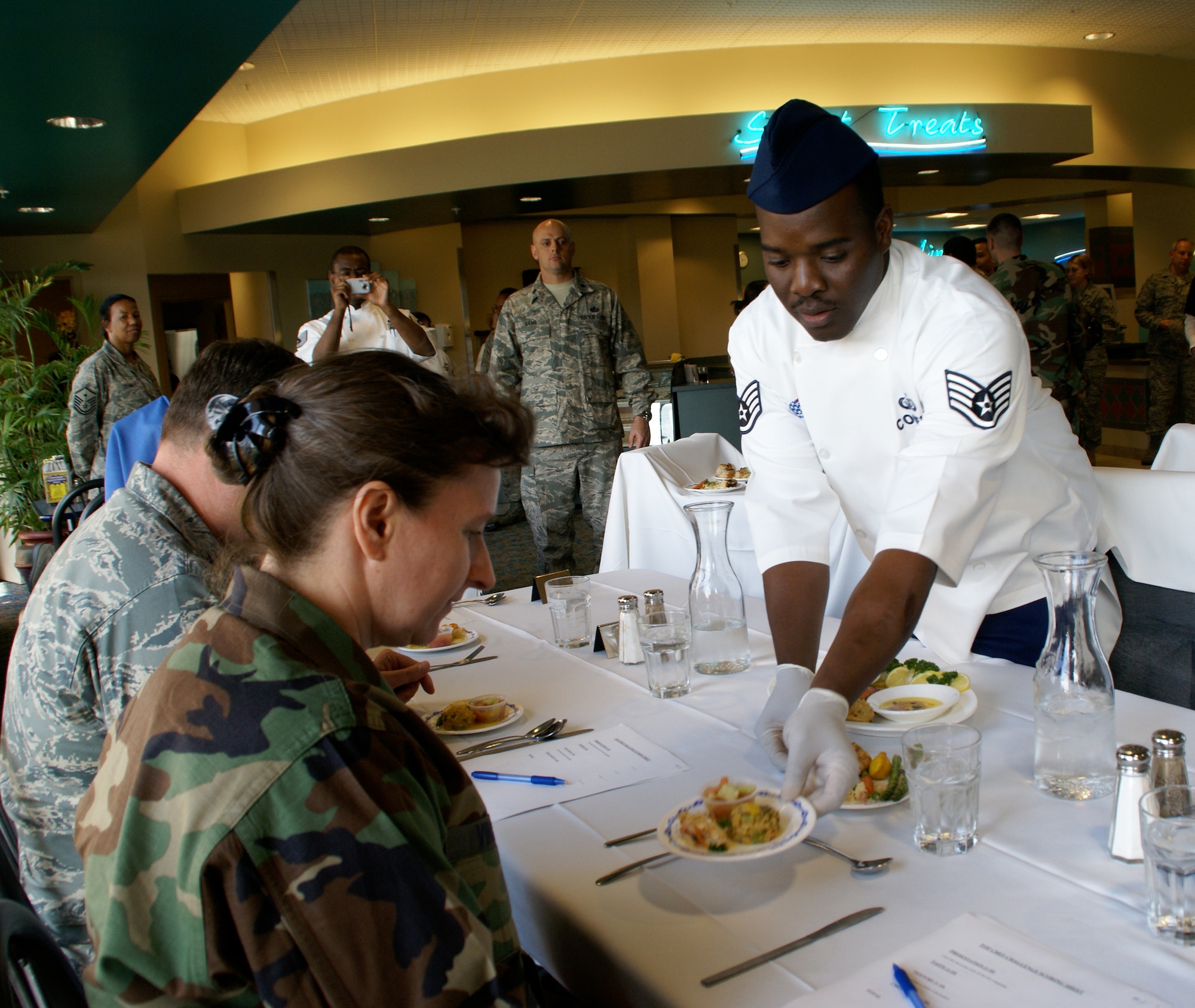 Col.Janice Vincent, 96 Mission Support Group commander, Eglin Air Force Base, Fla. receives a plate for judging from Staff Sgt. Jean Coleus.