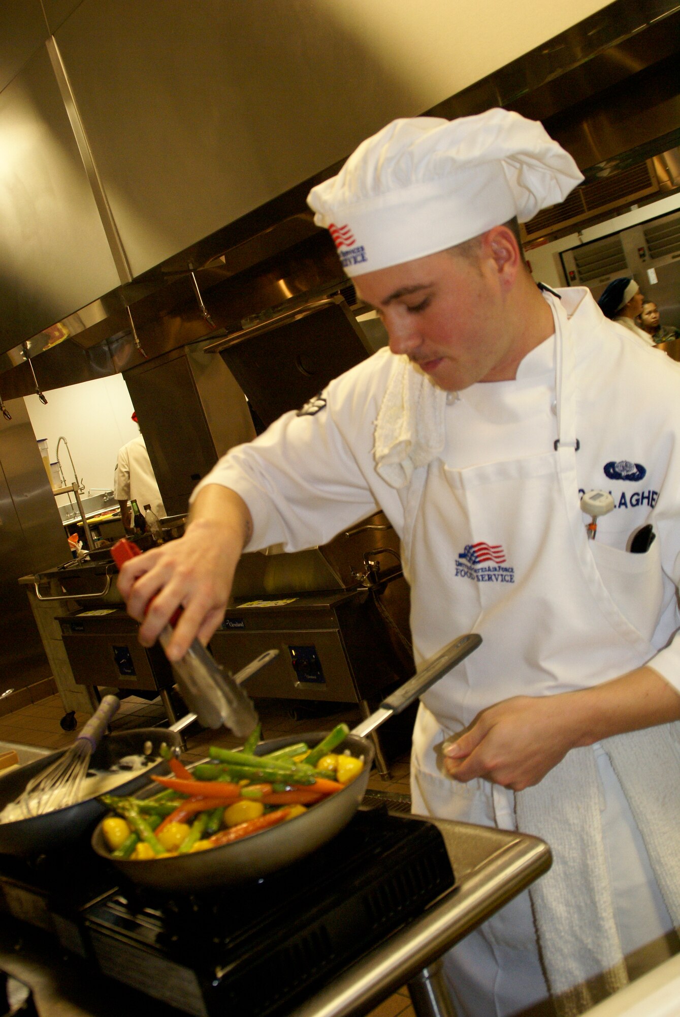 Airman First Class Christian Gallagher, Eglin Air Force Base, Fla., prepares his entry in the Top Chef competition.