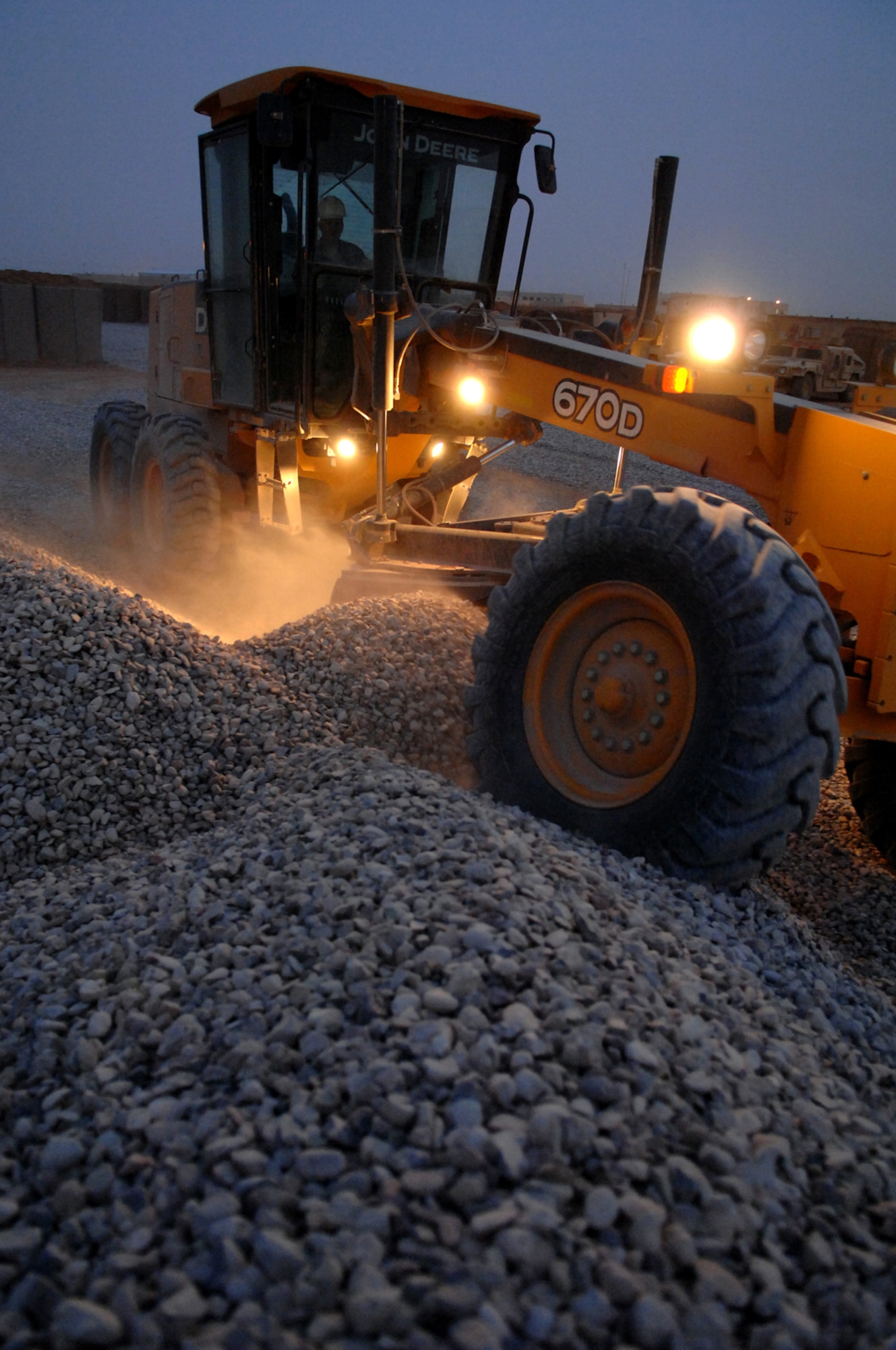 FORWARD OPERATING BASE CALDWELL, Iraq -- A grader levels gravel at the new maintenance yard here, March 3. The 732nd Expeditionary Civil Engineer Squadron Detachment 6 Airmen worked into the night spreading 9,000 cubic meters of gravel across a two million square-foot area to complete the project. (U.S. Air Force photo/ Senior Airman Julianne Showalter)
