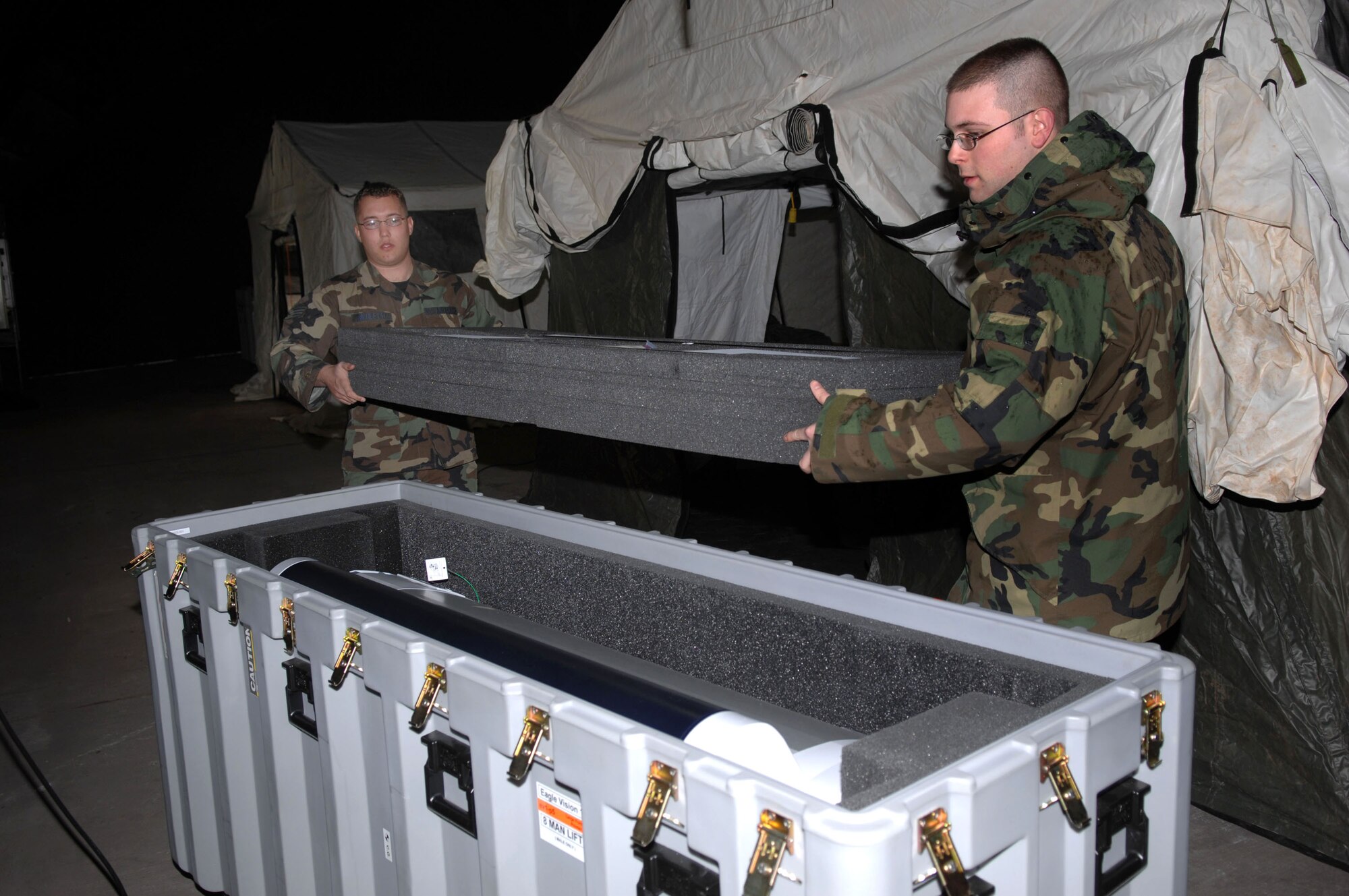 Senior Airmen Ryan Nicoletti and Adam Walters pack a large format printer for storage Feb. 29 at Ramstein Air Base, Germany. When deployed, the Eagle Vision-1 team creates hard copy prints of commercial satellite imagery. Both Airmen are commercial satellite imagery geospatial analysts. (U.S. Air Force photo/Senior Master Sgt. Hollis Dawson) 