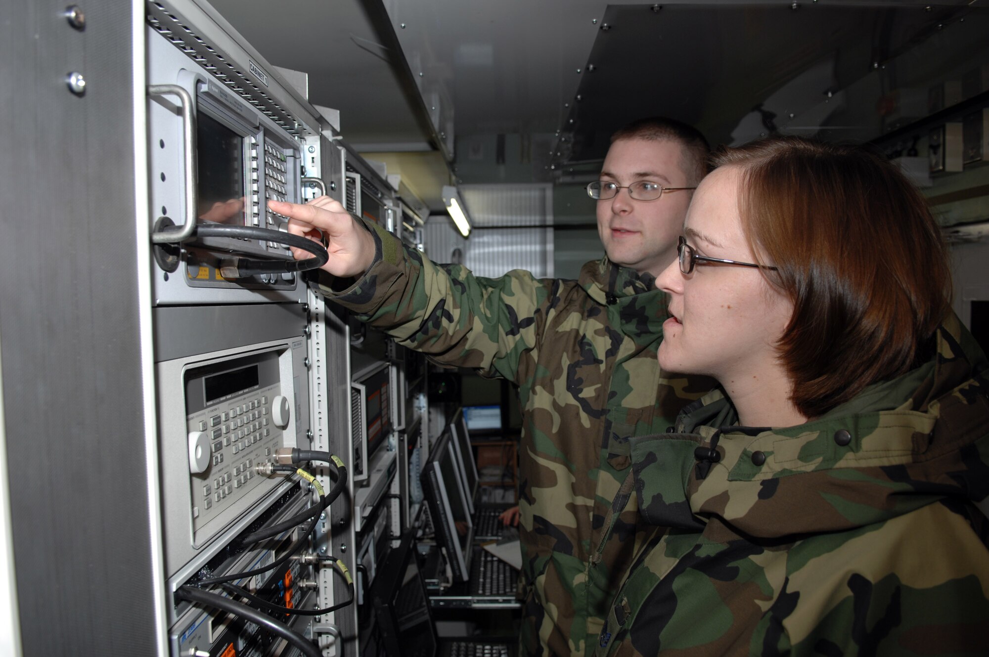 Senior Airman Adam Walters and Staff Sgt. Susanne Dehne program the setting on a spectrum analyzer Feb. 29 at Ramstein Air Base, Germany. The analyzer measures the strength of the signal received by the Eagle Vision-1 antenna from commercial satellites. Airman Walters is a commercial satellite imagery geospatial analyst and Sergeant Dehne is an imagery collection analyst. (U.S. Air Force photo/Senior Master Sgt. Hollis Dawson) 