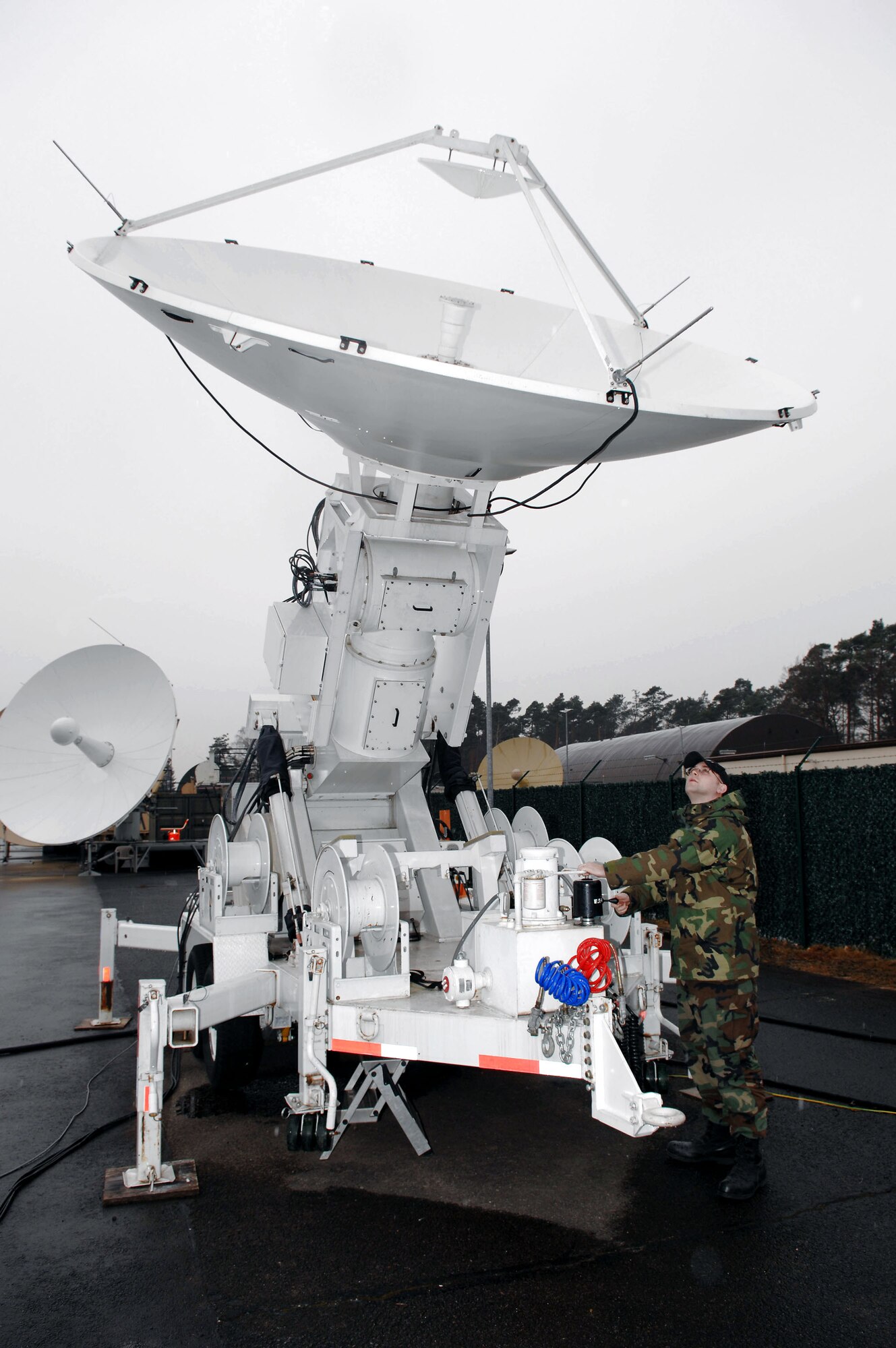 Senior Airman Adam Walters adjusts the angle of the Eagle Vision-1 antenna Feb. 29 at Ramstein Air Base, Germany. The EV-1 antenna is the team's primary source of communication with commercial satellites. (U.S. Air Force photo/Senior Master Sgt. Hollis Dawson) 
