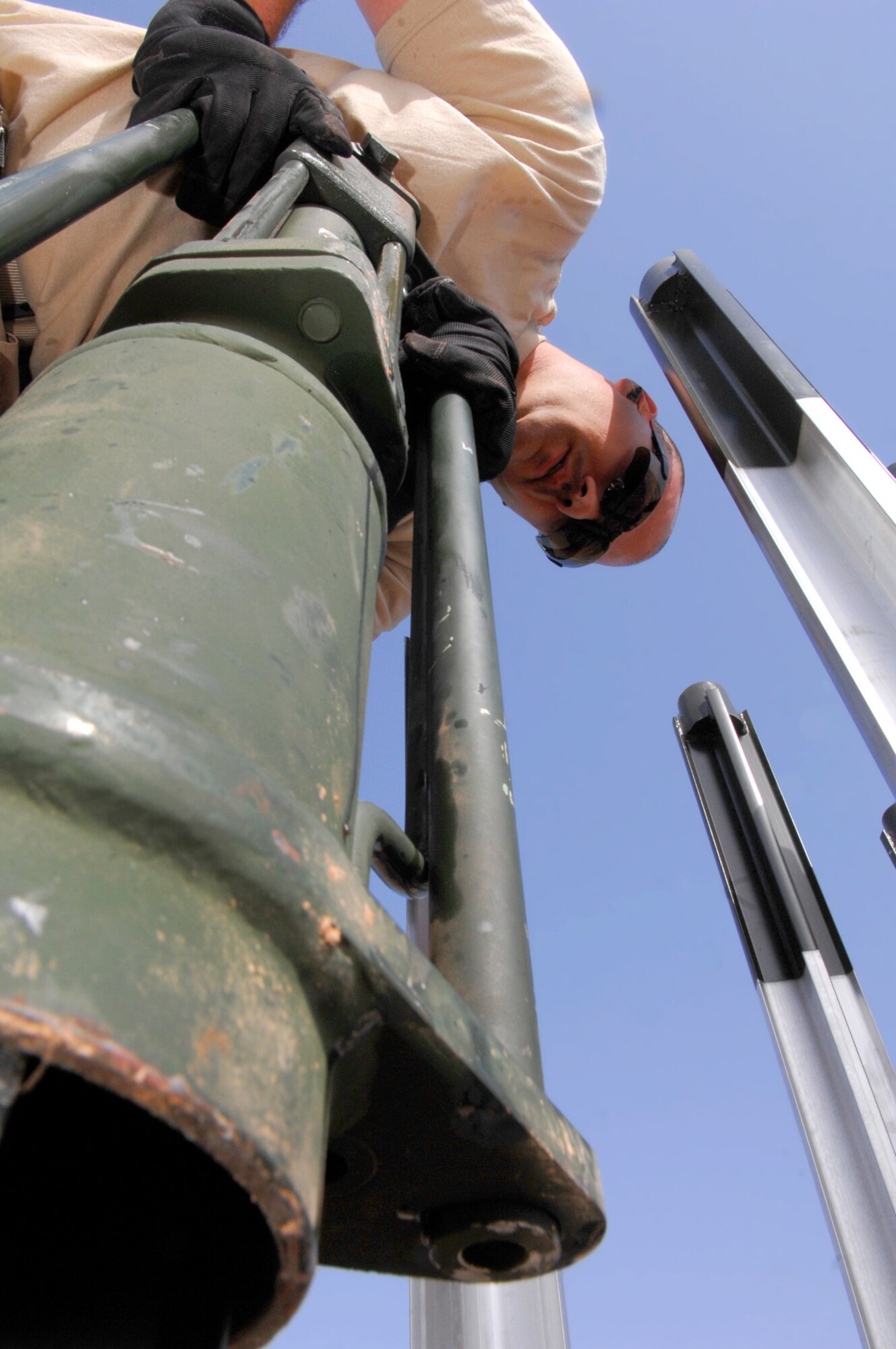 BALAD AIR BASE, Iraq -- Tech. Sgt. Randy Thibeau, 332nd Expeditionary Civil Engineer Squadron power production technician, holds a stake hammer as it pounds four-foot stake into the ground here, March 12. The stake prevents the arresting barrier system from shifting during an emergency landing. The barrier system gives the Air Force the ability to launch aircraft and recover them anywhere in the world. If a fighter aircraft experiences malfunctioning landing gear, the pilot can a drop a hook to catch a cable attached to the barrier system, which slows the aircraft and enables a smoother landing. Sergeant Thibeau is deployed from Ellsworth Air Force Base, S.D. (U.S. Air Force photo/ Senior Airman Julianne Showalter)