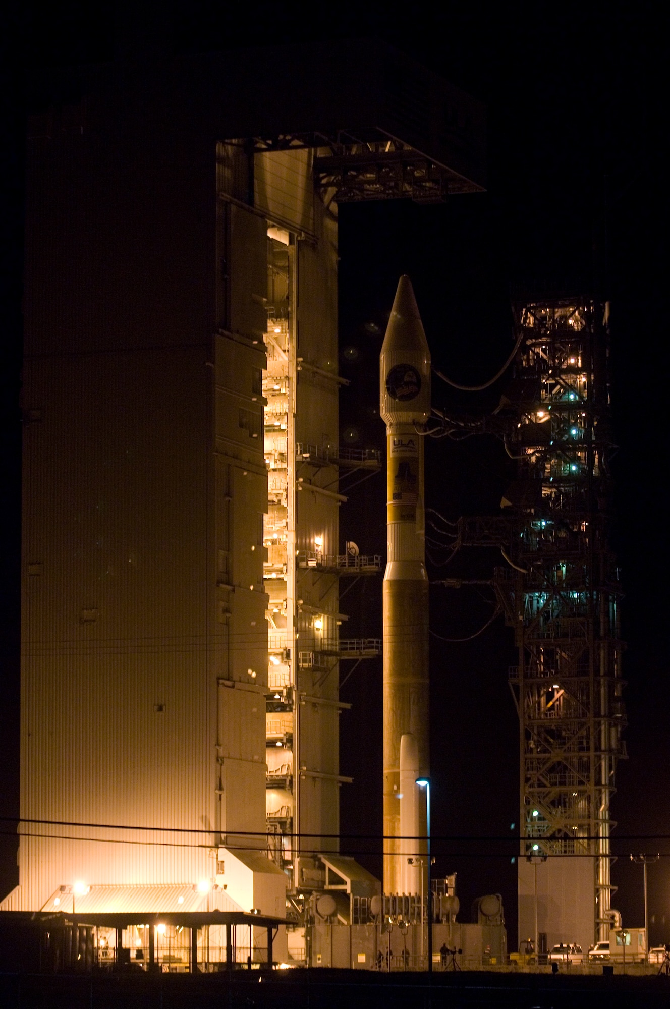 VANDENBERG AIR FORCE BASE, Calif. -- An Atlas V stands on Space Launch Complex-3 during its mobile servicing tower rollback on March 12. Col. Steve Tanous, 30th Space Wing commander, will be the space lift commander for this mission. This will be the first Atlas V launched from Vandenberg and the west coast, as well as the first launch of the year. This milestone for Team Vandenberg is the product of the combined efforts of the 30th Space Wing, the National Reconnaissance Office, United Launch Alliance, the Space and Missile Systems Center, the Aerospace Corporation and more. SLC 3 was significantly modified to get ready for the next generation of space launch vehicles. The Atlas V will be its first launch since the modifications were completed. Previously used for 21 Atlas II launches, the pad received significant upgrades to accommodate the larger and more powerful booster. The tower was made taller, the overhang was extended with a much bigger crane, and the entire pad deck was reconfigured. The pad also features a brand new fixed launch platform. (U.S. Air Force photo/Airman 1st Class Christian Thomas) 


