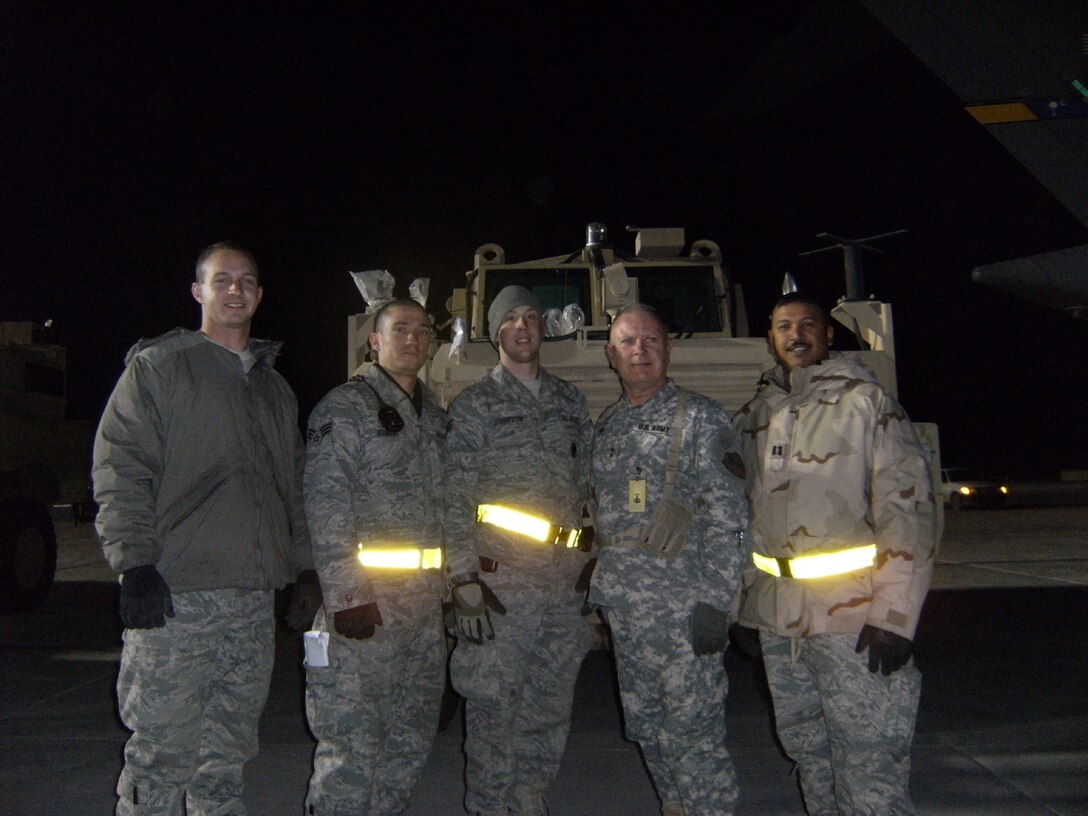 SEYMOUR JOHNSON AIR FORCE BASE, N.C. -- Capt. Neil Chandler (far right) stands in front of the first Mine Resistant Ambush Protected vehicle to be delivered to Afghanistan. Capt. Chandler is a Reservist with the 916th Logistics Readiness Squadron and deployed for Afghanistan in early January.