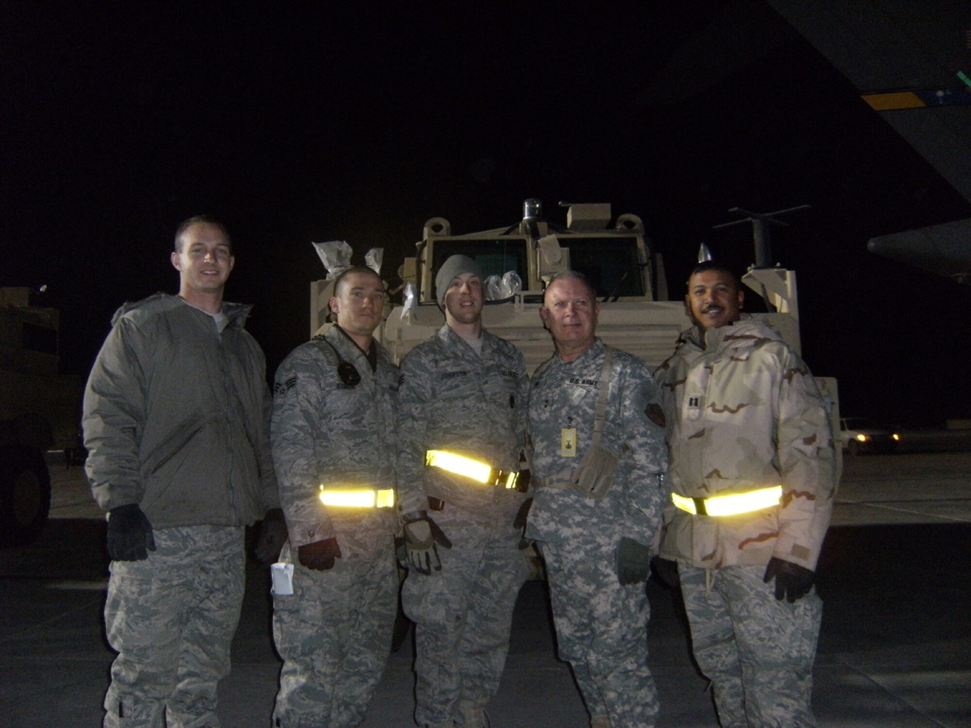 SEYMOUR JOHNSON AIR FORCE BASE, N.C. -- Capt. Neil Chandler (far right) stands in front of the first Mine Resistant Ambush Protected vehicle to be delivered to Afghanistan. Capt. Chandler is a Reservist with the 916th Logistics Readiness Squadron and deployed for Afghanistan in early January.