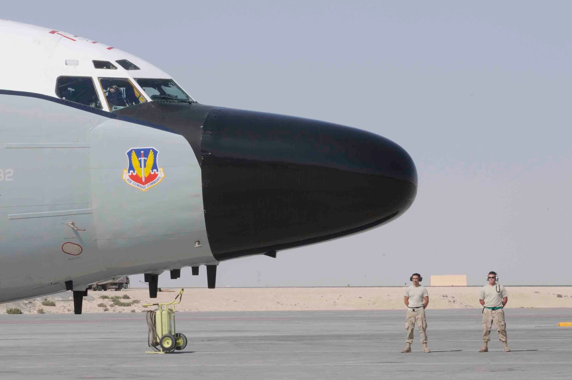 Airman 1st Class Dock Caudhill and Staff Sgt. Casey M. Bode, 379th Expeditionary Aircraft Maintenance Squadron, standby for aircraft to taxi at a Southwest Asia air base March 12. Airman Caudhill and Sergeant Casey ensure aircraft has proper wing clearance from any obstructions before departing parking spot.  Airman Caudhill is from Eugene, OR and Sergeant Casey is from Petersburg, NE.  Both deployed from Offutt Air Force Base, NE. (U.S. Air Force photo/Tech. Sgt. Johnny L. Saldivar)