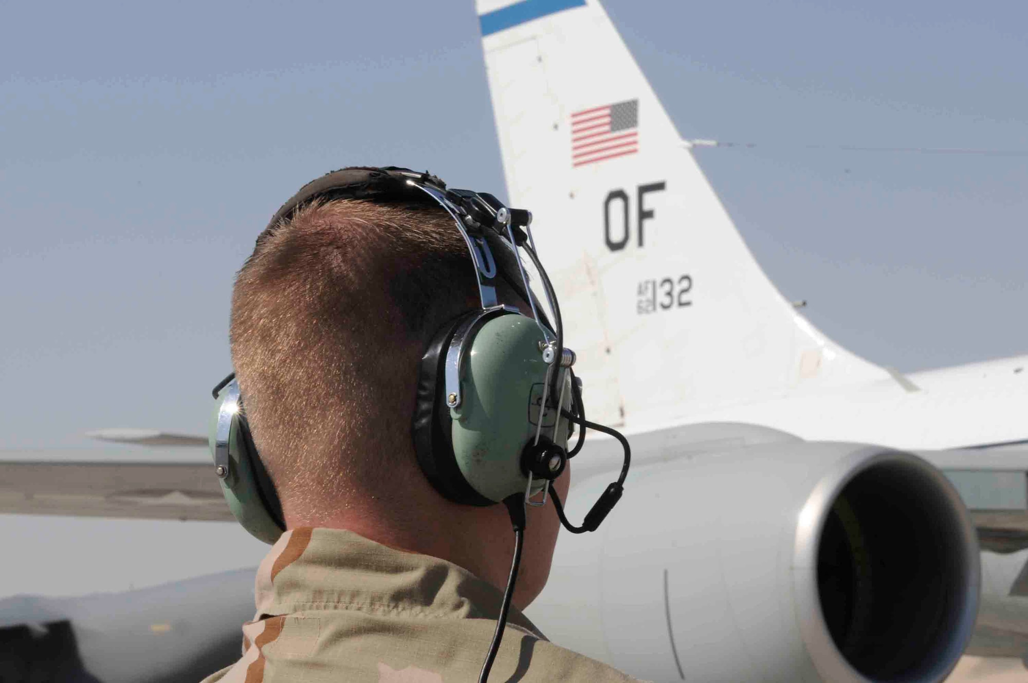 Senior Airman Joshua Sexton, 379th Expeditionary Aircraft Maintenance Squadron, communicates with aircraft pilot at a Southwest Asia air base March 12. Airman Sexton is the eyes and ears for the outside of the aircraft while pilots perform pre-flight checks. He is from Springfield, IL deployed from Offutt Air Force Base, NE. (U.S. Air Force photo/Tech. Sgt. Johnny L. Saldivar)