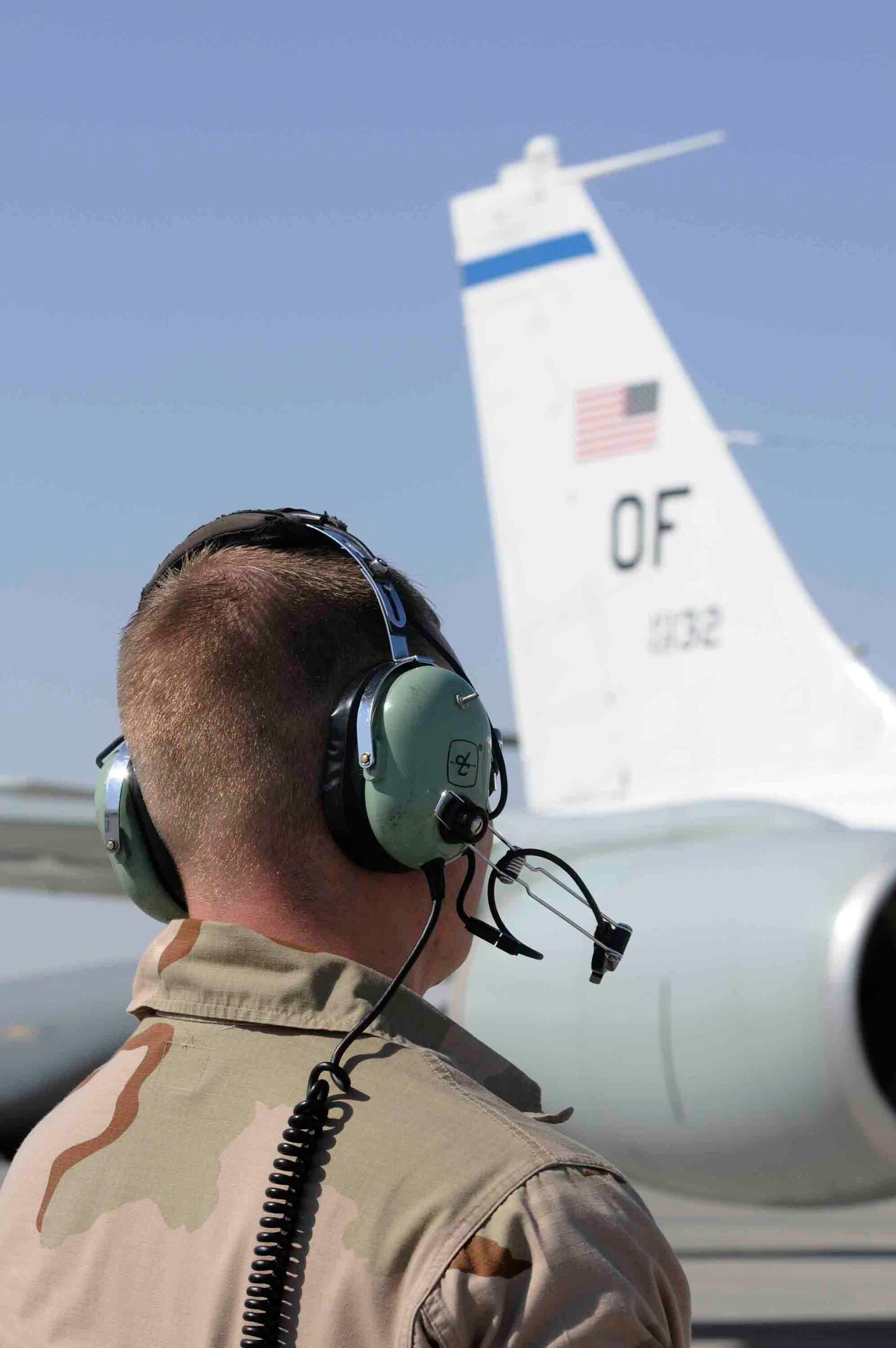 Senior Airman Joshua Sexton, 379th Expeditionary Aircraft Maintenance Squadron, communicates with aircraft pilot at a Southwest Asia air base March 12. Airman Sexton is the eyes and ears for the outside of the aircraft while pilots perform pre-flight checks. He is from Springfield, IL deployed from Offutt Air Force Base, NE. (U.S. Air Force photo/Tech. Sgt. Johnny L. Saldivar)