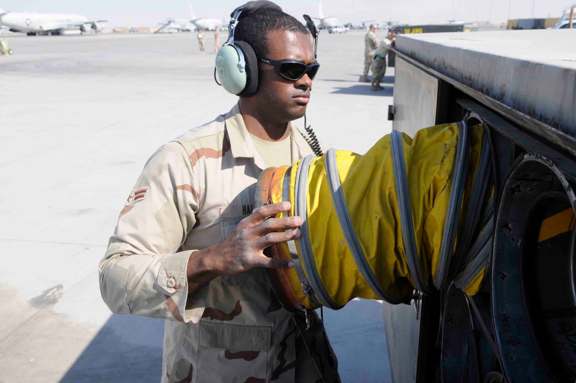 Airman 1st Class Michael Hall, 379th Expeditionary Reconnaissance Squadron, stores hoses removed from aircraft at a Southwest Asia air base March 12. Aircraft hoses are used to keep the inside of aircraft cool.  He is from Tampa, FL deployed from Offutt Air Force Base, NE. (U.S. Air Force photo/Tech. Sgt. Johnny L. Saldivar)