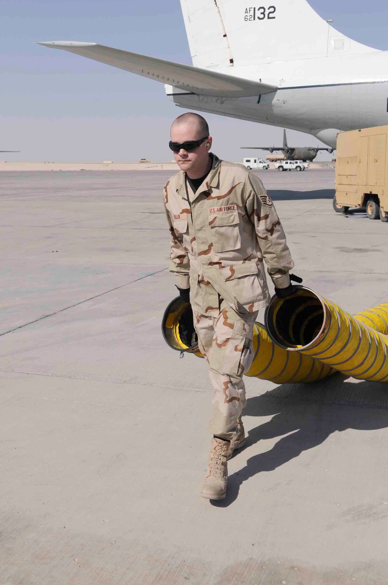 Staff Sgt. James A. Mellon, 379th Expeditionary Reconnaissance Squadron, removes hoses from aircraft at a Southwest Asia air base March 12. Aircraft hoses are used to keep the inside of aircraft cool.  He is from Effort, PA deployed from Offutt Air Force Base, NE. (U.S. Air Force photo/Tech. Sgt. Johnny L. Saldivar)