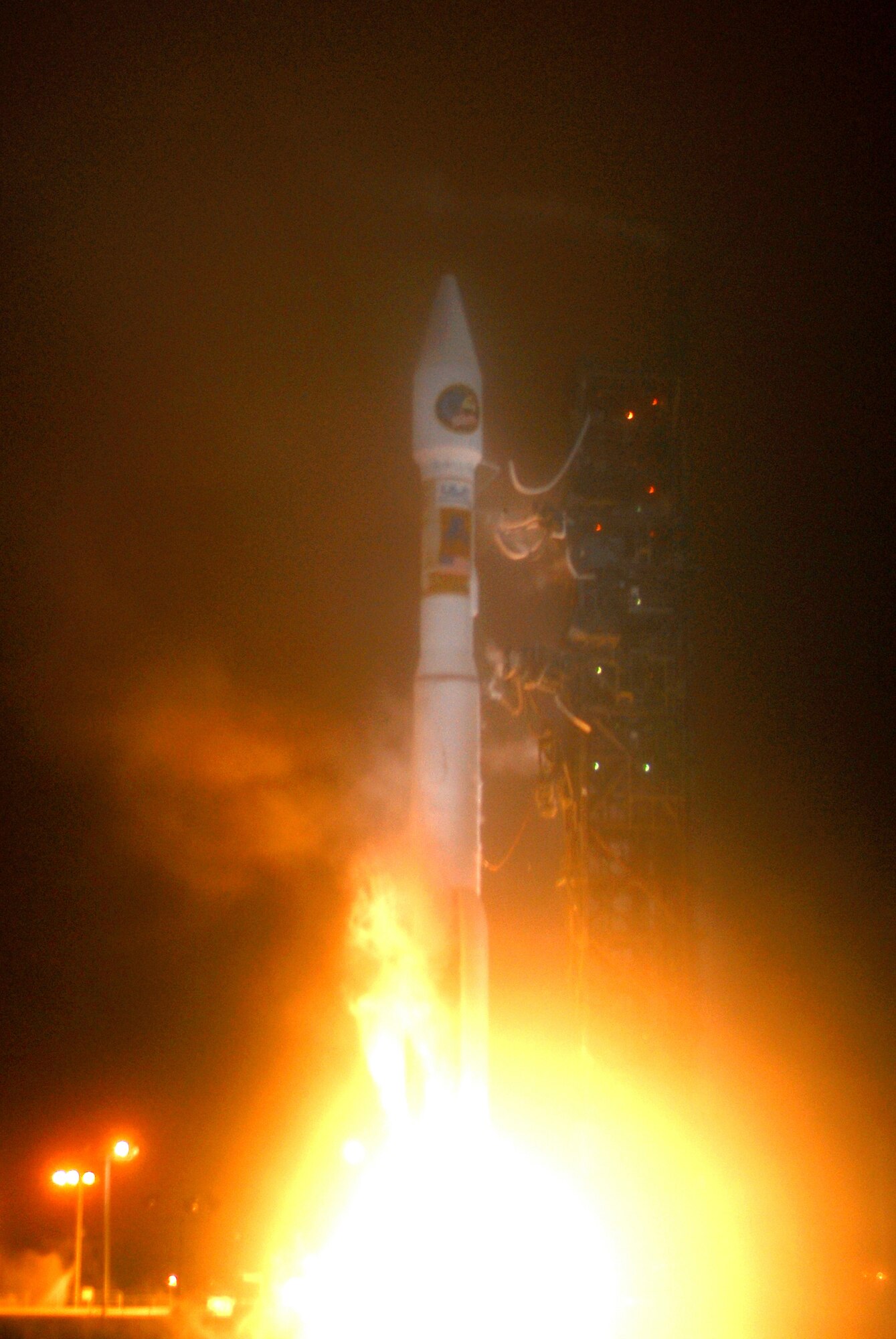 VANDENBERG AIR FORCE BASE, Calif. -- An Atlas V launches from Space Launch Complex-3 on March 13. Col. Steve Tanous, 30th Space Wing commander, was the space lift commander for this mission. This was the first Atlas V launched from Vandenberg and the west coast, as well as the first launch of the year. This milestone for Team Vandenberg is the product of the combined efforts of the 30th Space Wing, the National Reconnaissance Office, United Launch Alliance, the Space and Missile Systems Center, the Aerospace Corporation and more. SLC 3 was significantly modified to get ready for the next generation of space launch vehicles. The Atlas V will be its first launch since the modifications were completed. Previously used for 21 Atlas II launches, the pad received significant upgrades to accommodate the larger and more powerful booster. The tower was made taller, the overhang was extended with a much bigger crane, and the entire pad deck was reconfigured. The pad also features a brand new fixed launch platform. (U.S. Air Force photo/Joe Davila) (Released)