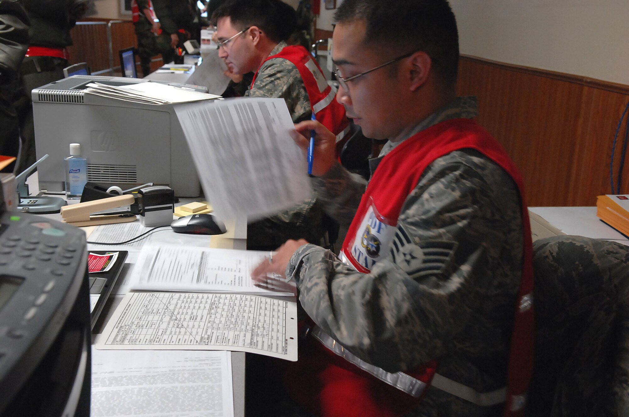 MOUNTAIN HOME AIR FORCE BASE, Idaho -- Staff Sgt. Eric Pinlac, 366th Aeromedical Dental Squadron public health specialist, reviews medical documents for deployers during Exercise Coronet White 08-ACC-14 March 14. The 366th Fighter Wing is participating in an Operational Readiness Inspection March 13-21 to test the wing's ability to deploy and take its mission to war. (U.S. Air Force photo by Staff Sgt. Kathy Parker) 