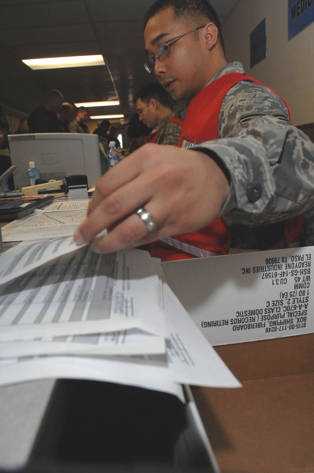 MOUNTAIN HOME AIR FORCE BASE, Idaho -- Staff Sgt. Eric Pinlac, 366th Aeromedical Dental Squadron public health specialist, reviews medical documents for deployers during Exercise Coronet White 08-ACC-14  March 14. The 366th Fighter Wing is participating in an Operational Readiness Inspection March 13-21 to test the wing's ability to deploy and take its mission to war. (U.S. Air Force photo by Staff Sgt. Kathy Parker)
