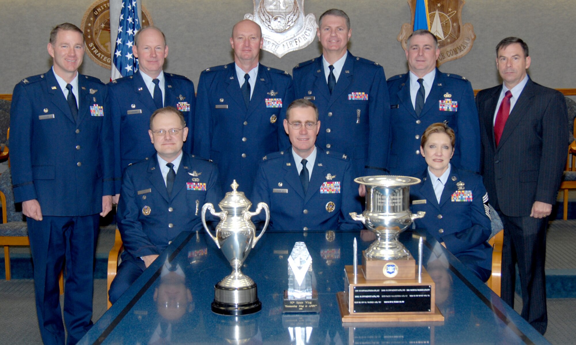 Wing leadership displays the three trophies and awards Warren has earned. The Omaha trophy represents the best ICBM wing in U.S. Strategic Command. The Morman award recognizes the best space wing overall in Air Force Space Command. The Williams award goes to the best space wing with an ICBM mission in AFSPC (U.S. Air Force photo/Bernie Ernst).
