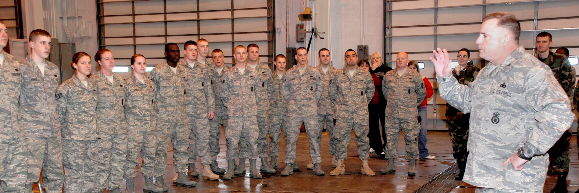 Col. David Martinez (right), 90th Security Forces Group commander, speaks with the deploying security forces members before the barbecue March 7.