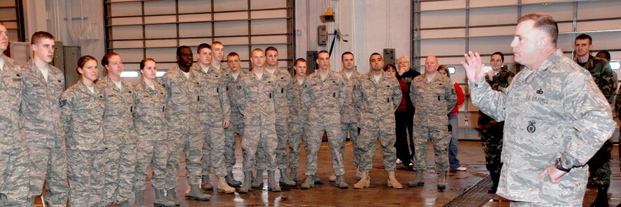 Col. David Martinez (right), 90th Security Forces Group commander, speaks with the deploying security forces members before the barbecue March 7.