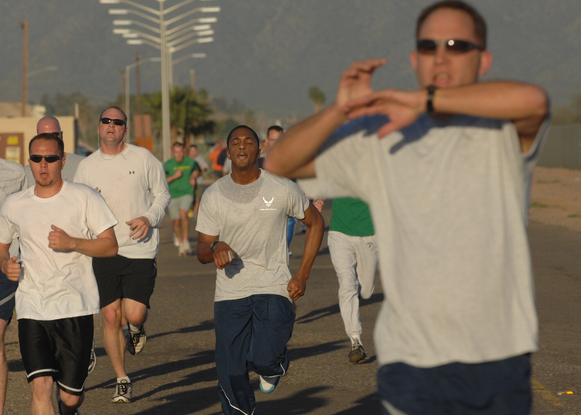 Runners complete the final push across the finish line during the St. Patrick's Day 5K fun run on Mar. 14. More than 280 runners participated in the early morning run. The 56th Services Squadron sponsors the monthly 5K run at Luke Air Force Base, Ariz. (U.S. Air Force photo/Tech. Sgt. Raheem Moore)