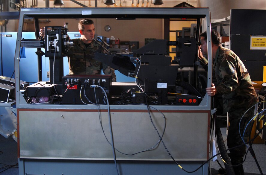 Technical. Sgt. James Erickson (left) and Master Sgt. Onyx Banez check a Head-Up Display (HUD) of a C-17 Globemaster III cargo aircraft using a Display Unit Test Set (DUTS) at March Air Reserve Base, Calif. Avionics technicians install, maintain and repair electronic and electrical systems on all types of aircraft and they also maintain a high degree of readiness here to deploy worldwide to support wartime and contingency operations and operations other than war in support of national interests and objectives. (U.S. Air Force photo by Val Gempis)