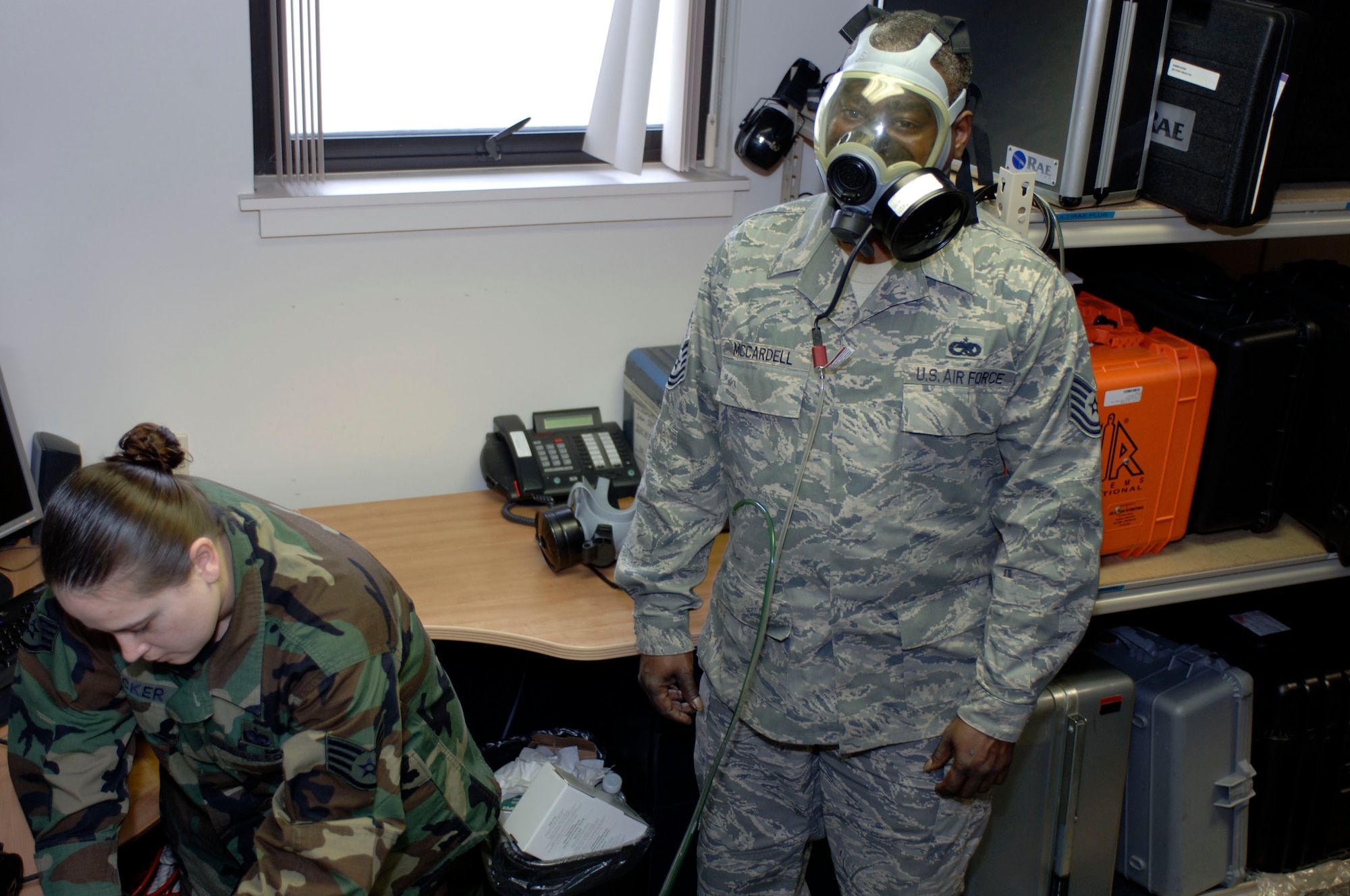LANGLEY AIR FORCE BASE, Va. -- Staff Sgt. Jennifer Flecker, 1st Aerospace Medicine Squadron aerospace physiology logistics noncommissioned officer in charge (left), performs a gas mask fit test on Tech. Sgt. Eugene McCardell, 1st Maintenance Group Air Force repair enhancement program manager, March 14. The gas mask fit test is a requirement for all Airmen participating in the upcoming operational readiness exercise March 17 through 22. These tests ensure masks fit properly and no hazardous chemicals can reach an Airman’s respiratory system. (U.S. Air Force photo/Airman 1st Class Chase Skylar DeMayo)