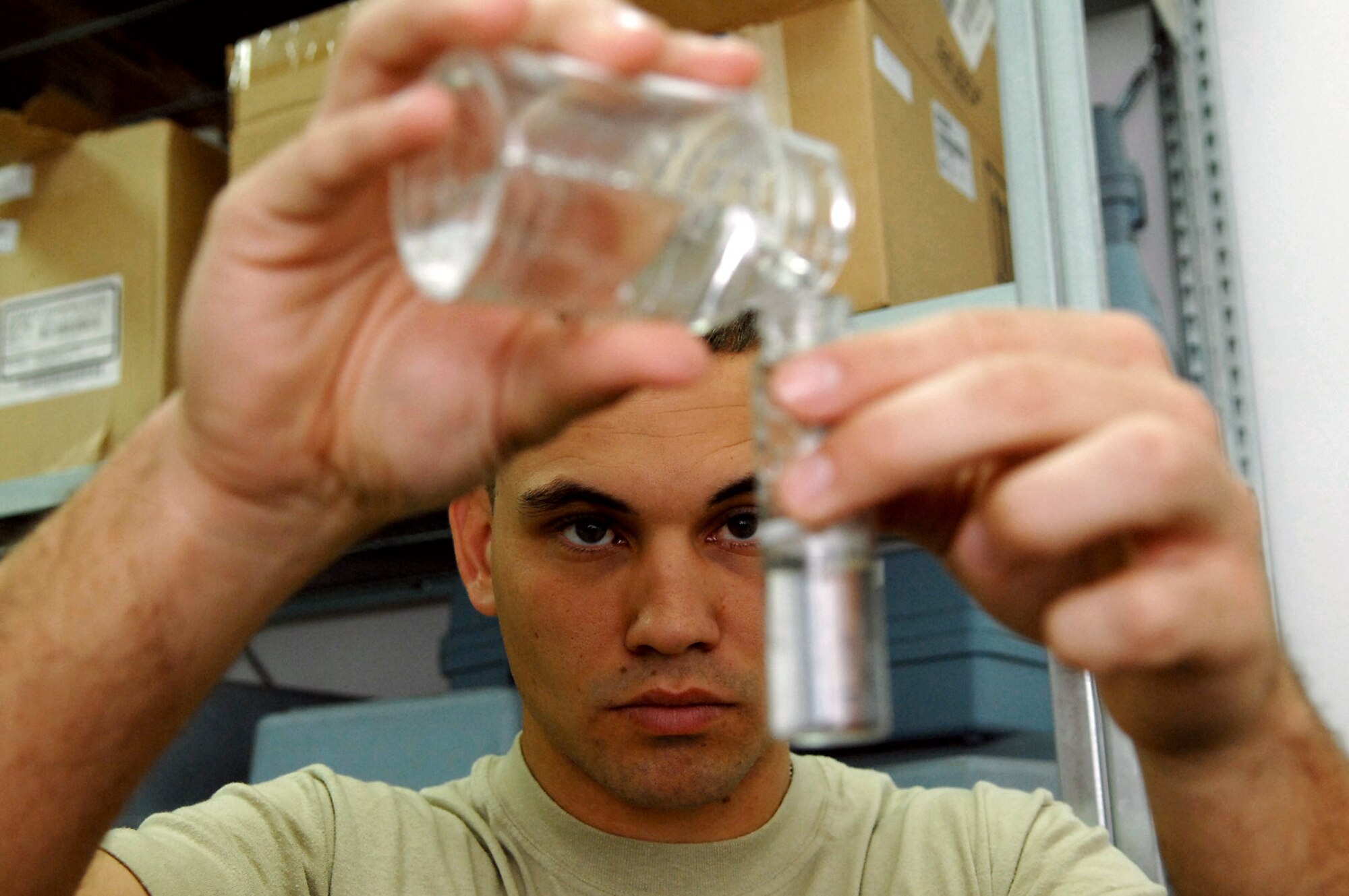Staff Sgt. Gary Messer transfers a sample of tap water to a tube before performing tests to confirm that the water is free from bacteria March 13 at Balad Air Base, Iraq. Sergeant Messer, a 332nd Expeditionary Aerospace Medical Squadron bioenvironmental engineer, is deployed from Lackland Air Force Base, Texas. (U.S. Air Force photo/Senior Airman Julianne Showalter) 
