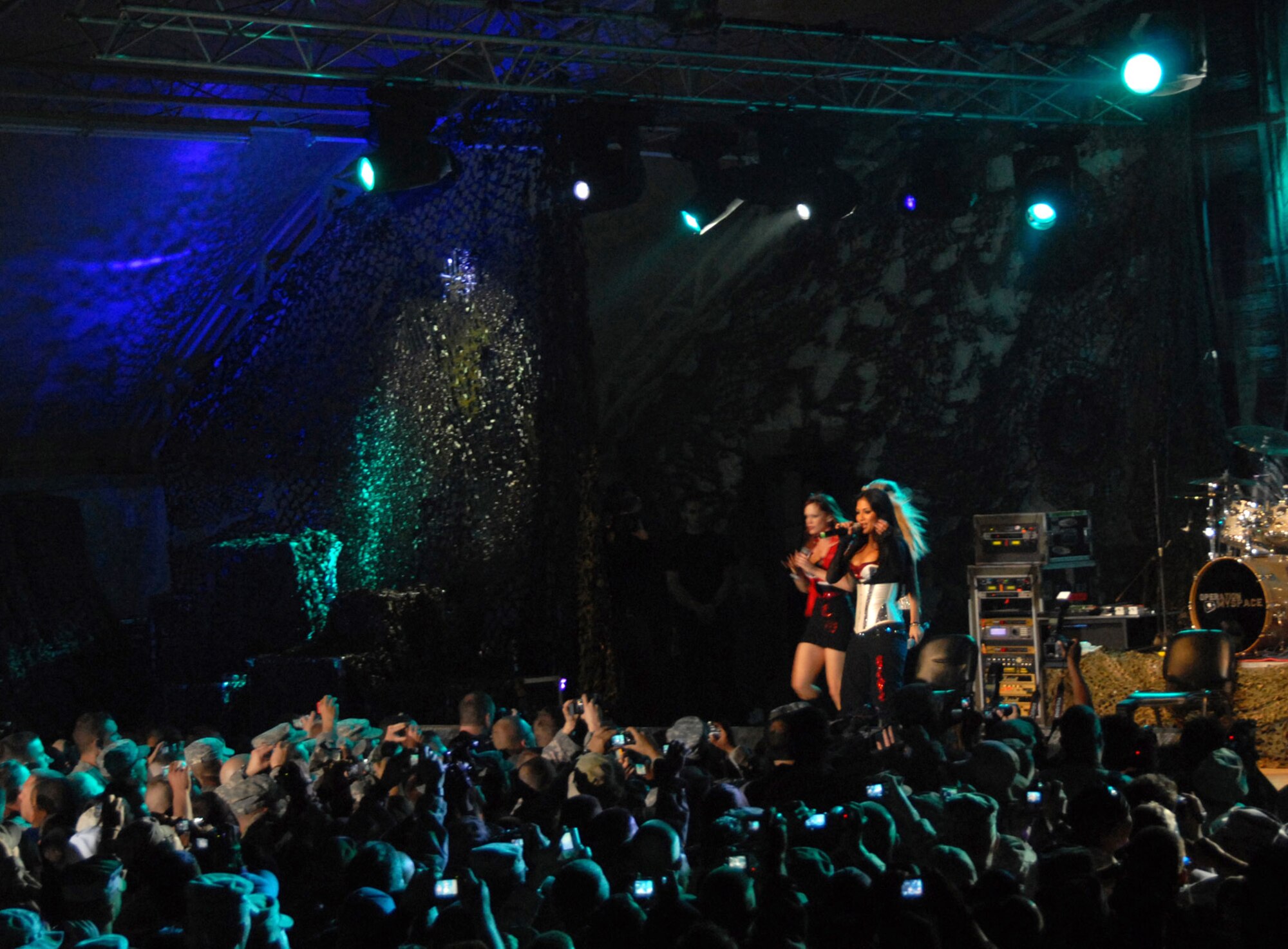 The Pussycat Dolls perform one of their songs for more than 2,000 U.S. and coalition servicemembers during a live concert March 10 at a U.S. Army camp in Southwest Asia. MySpace, in cooperation with Department of Defense's Armed Forces Entertainment and America Supports You program, brought Operation MySpace to servicemembers headed into and out of Afghanistan and Iraq. This landmark concert, with entertainment acts from Disturbed, Filter, Pussycat Dolls, DJ Z-Trip, and host Carlos Mencia, provided a taste of home via the wonder of live music to troops supporting operations Enduring Freedom and Iraqi Freedom. (U.S. Air Force photo/Staff Sgt. Patrick Dixon) 