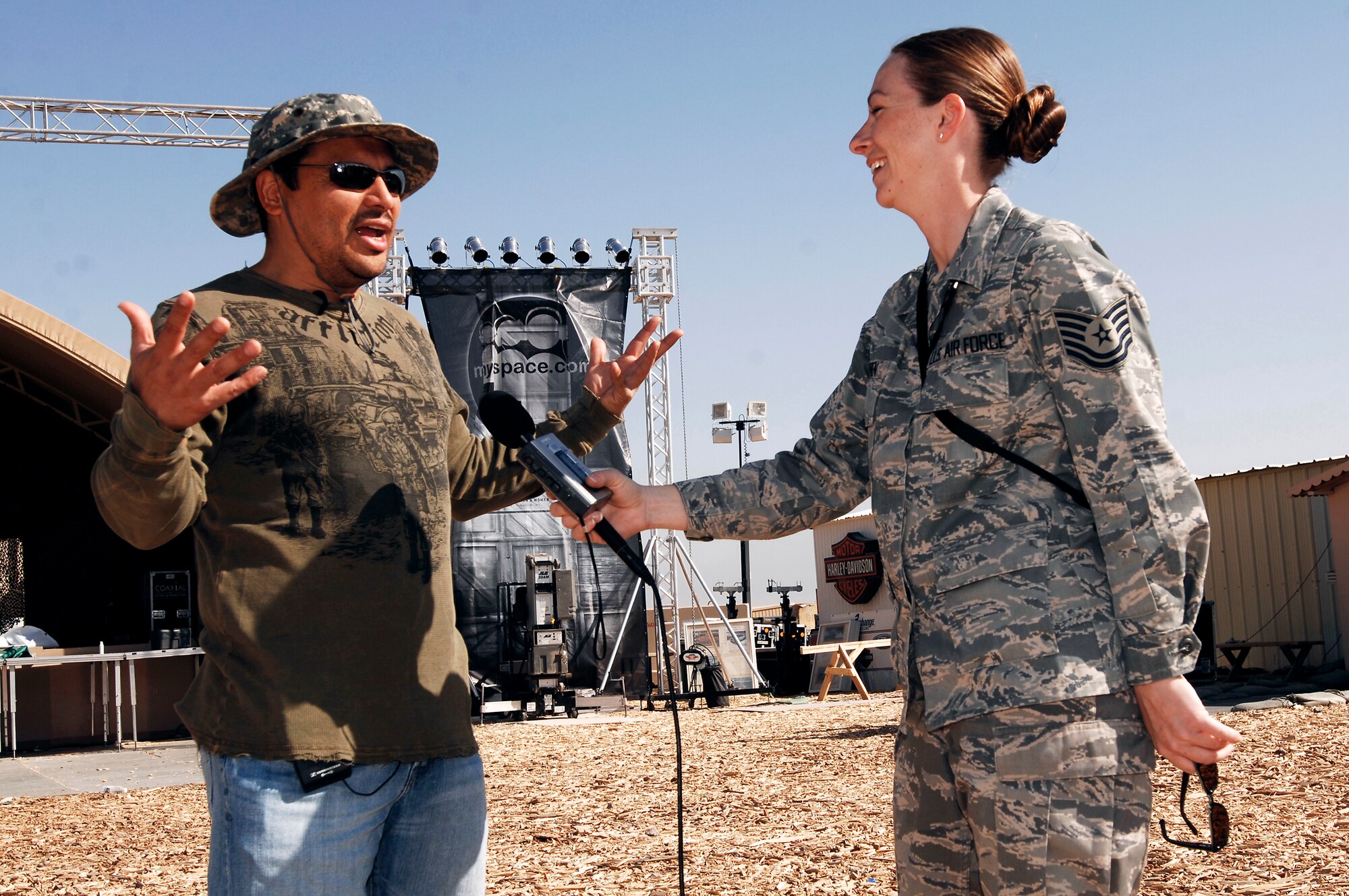 Tech. Sgt. Tara O'Brien interviews world renowned comedian Carlos Mencia prior to a live concert March 9 at a U.S. Army camp in the Persian Gulf Region. MySpace, in cooperation with Department of Defense's Armed Forces Entertainment and America Supports You program, brought Operation MySpace to servicemembers headed into and out of Afghanistan and Iraq. This landmark concert, with entertainment acts from Disturbed, Filter, Pussycat Dolls, disc jockey Z-Trip, and host Carlos Mencia, provided a taste of home via the wonder of live music to troops supporting operations Enduring Freedom and Iraqi Freedom. Sergeant O'Brien is a Broadcast Journalist for the Combined Air Operations Center and is deployed from Aviano Air Base, Italy. (U.S. Air Force photo/Staff Sgt. Patrick Dixon) 