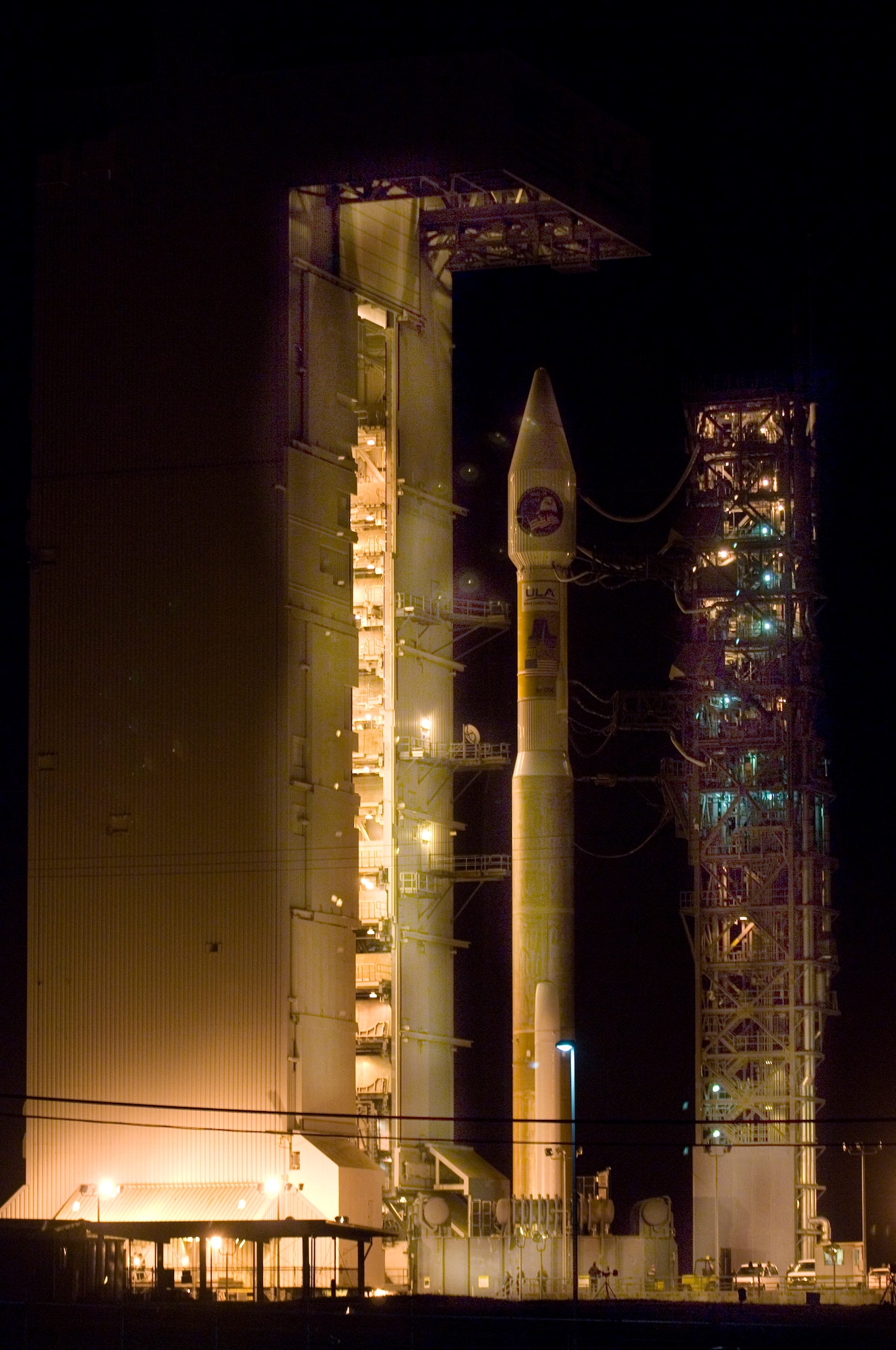 An Atlas V stands on Space Launch Complex-3 during its mobile servicing tower rollback on March 12.  The Atlas launched at 3:01 a.m. PDT March 13 at Vandenberg Air Force Base, Calif.  It carried a National Reconnaissance Office payload and was the first Atlas V to launch from the West Coast.  (U.S. Air Force photo/Airman 1st Class Christian Thomas)