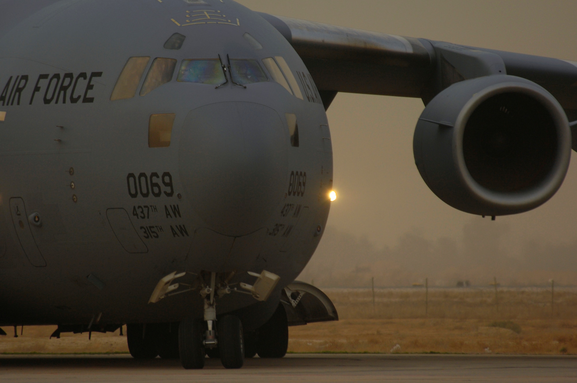 SATHER AIR BASE, Iraq -- A C-17 Globemaster III taxis through a mild evening dust storm here March 11. Since the start of 2008, Sather personnel are responsible for the movement and coordination of over 116,000 passengers and 11,000 tons of baggage on 5,700 missions. (U.S. Air Force photo/Tech. Sgt. Jeffrey Allen)