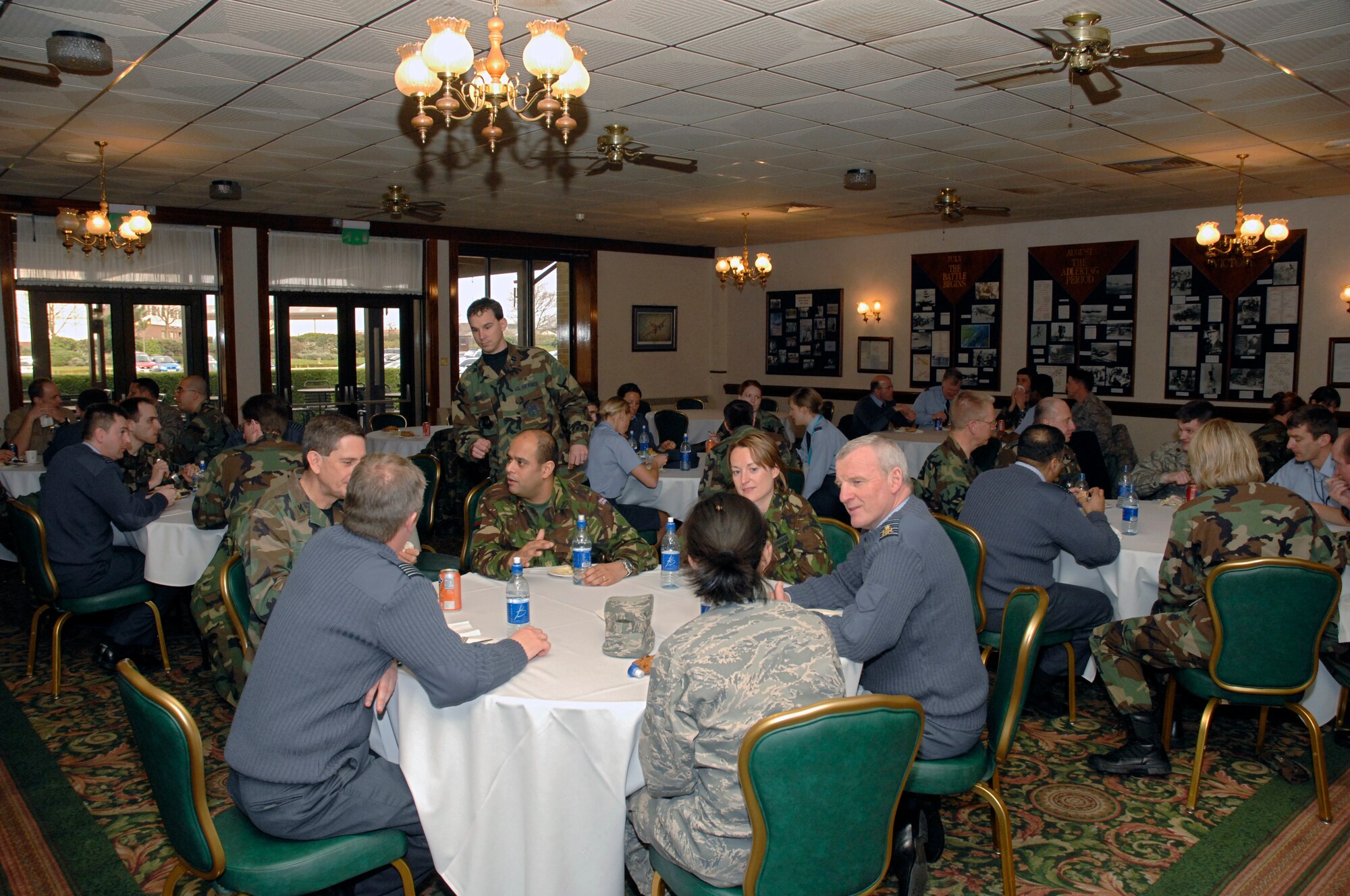 Airmen from the 48th Dental Squadron sit down for lunch with Royal Air Force, Royal Navy and the British Army dental personnel at the Eagles Landing March 12 at RAF Lakenheath. The conference, which is an annual event, is designed to allow U.S. and U.K. dentists to meet each year to discuss new practices in the career field. (U.S. Air Force photo by Airman Perry Aston)