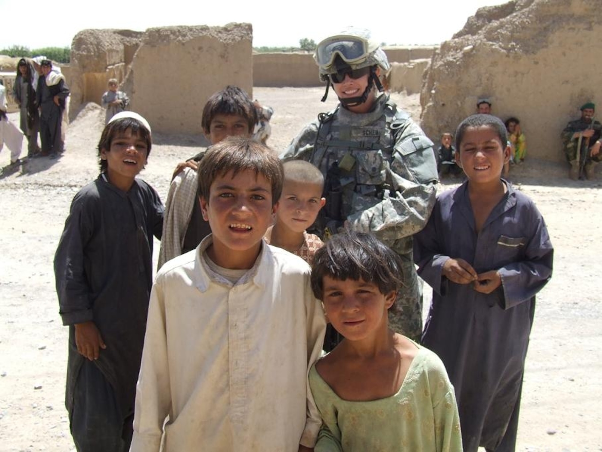 Staff Sgt. Trisha Scheu with some local children during her recent deployment to Afghanistan on an "in lieu of" assignment augmenting Army troops. (U.S. Air Force photo courtesy of Staff Sgt. Trisha Scheu