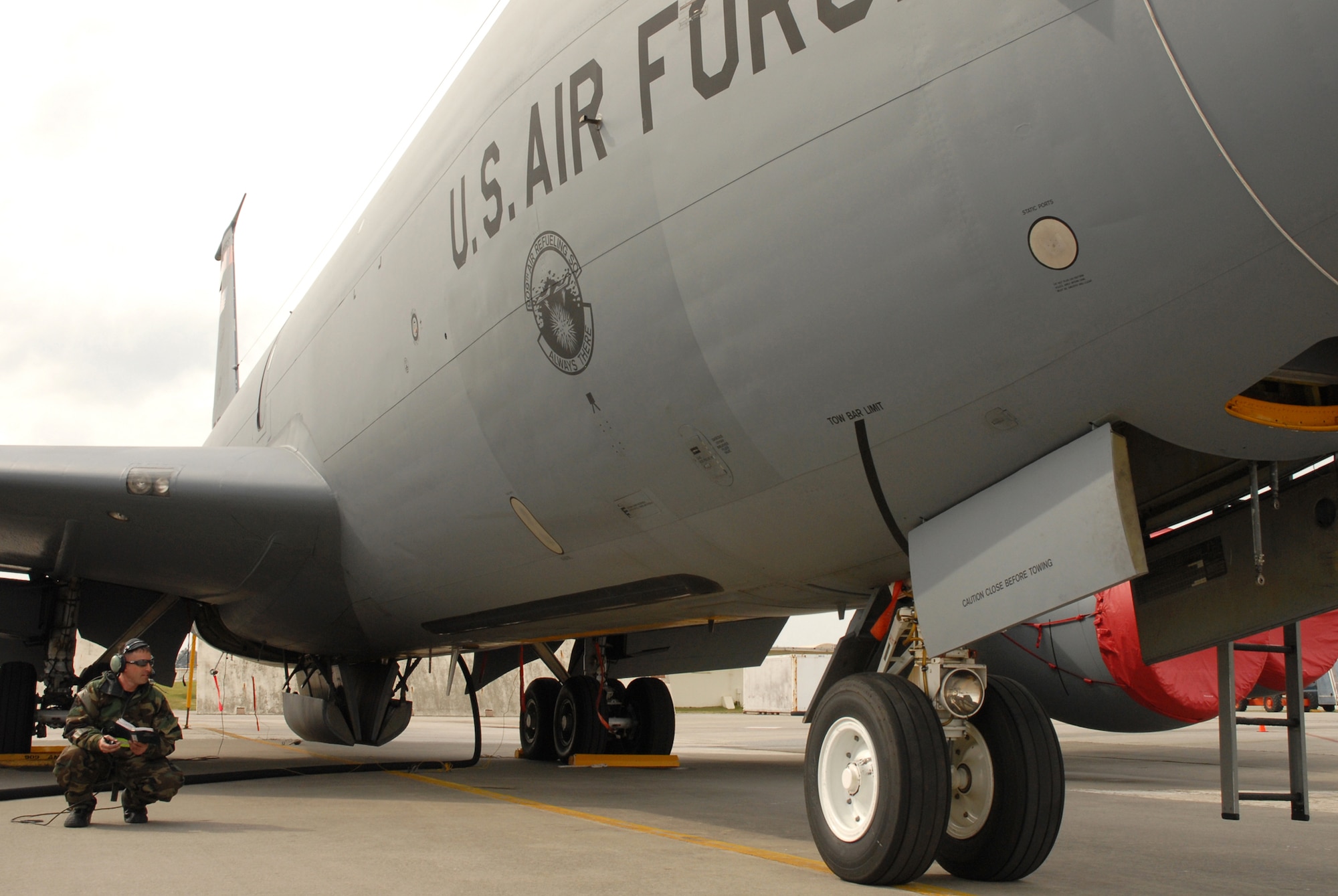Tech. Sgt Chris Harris, 718th Aircraft Maintenance Squadron, watches a KC-135 Stratotanker as it takes on more fuel and references the technical order to ensure all is in order, during the 2008 Pacific Air Forces Operational Readiness Inspection at Kadena Air Base, Japan, March 13, 2008. PACAF is conducting the inspection from March 9 to 15 to validate the mission readiness of the 18th Wing. (U.S. Air Force photo/Staff Sgt. Chrissy FitzGerald) (Released)