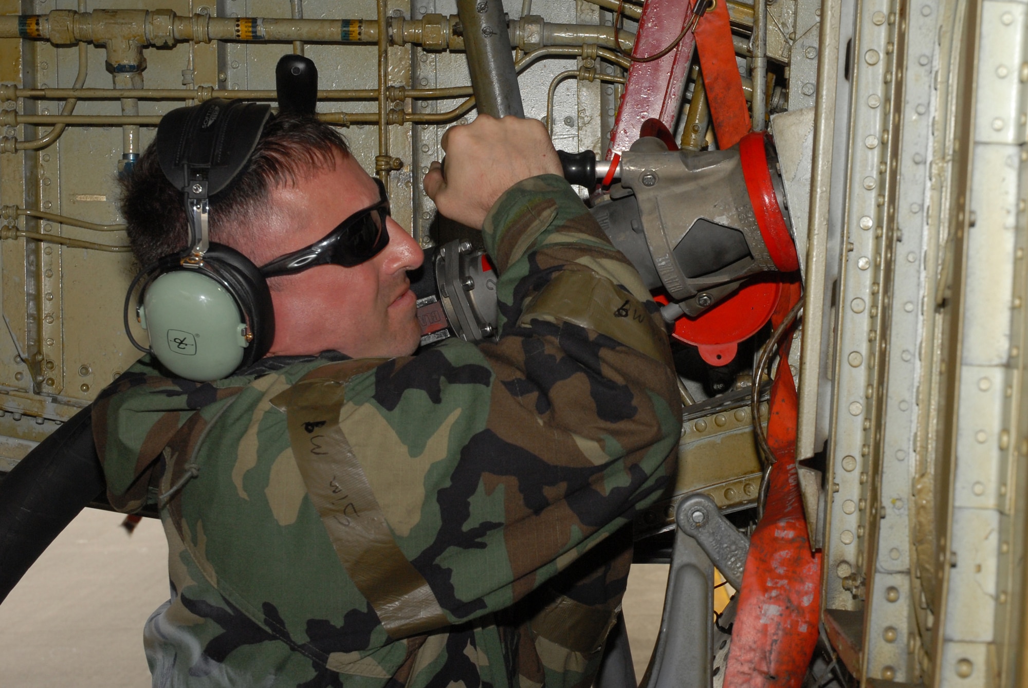 Tech. Sgt Chris Harris, 718th Aircraft Maintenance Squadron, connects a fuel hose to a KC-135 Stratotanker, during the 2008 Pacific Air Forces Operational Readiness Inspection at Kadena Air Base, Japan, March 13, 2008. PACAF is conducting the inspection from March 9 to 15 to validate the mission readiness of the 18th Wing. (U.S. Air Force photo/Staff Sgt. Chrissy FitzGerald) 