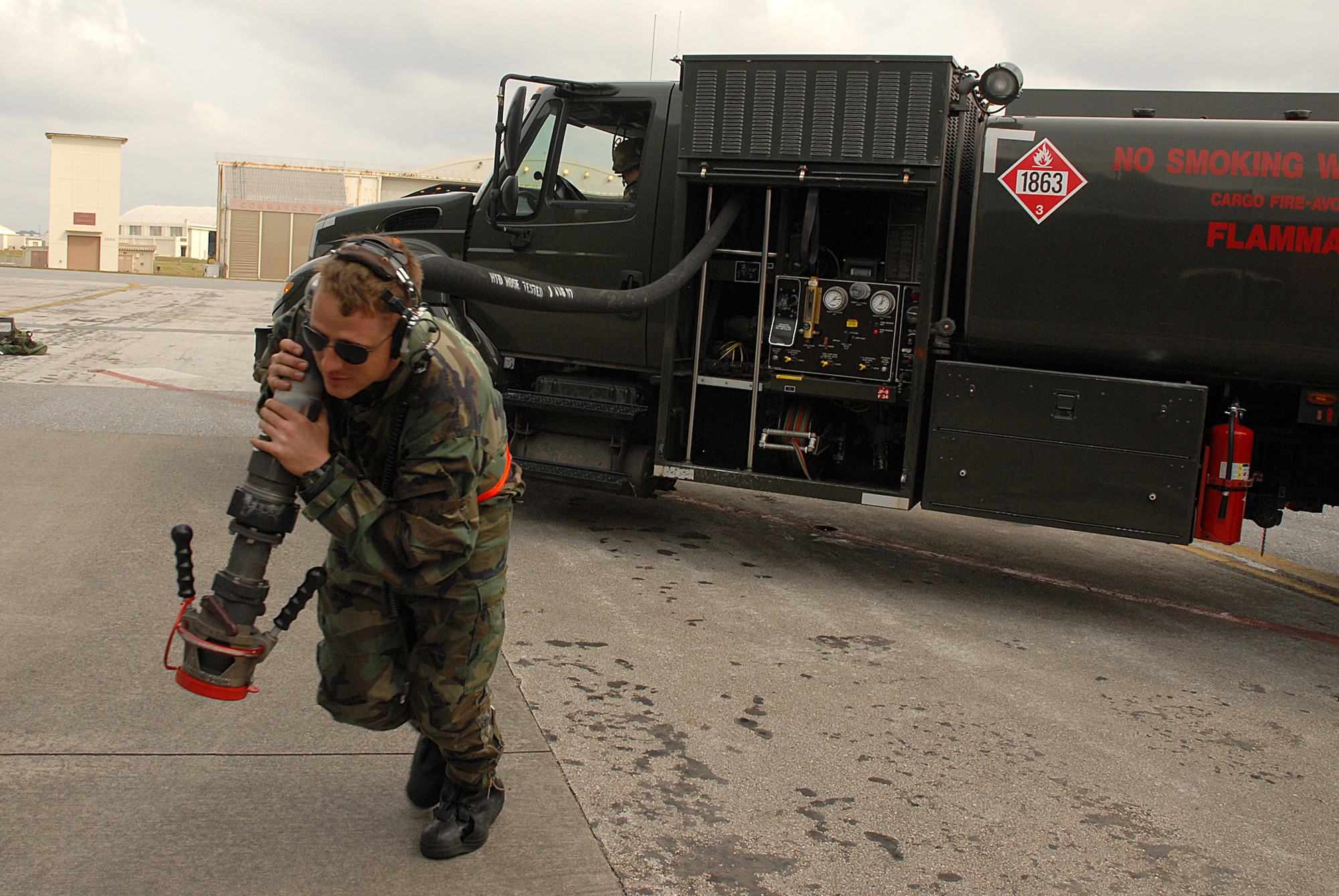Airman 1st Class Daniel Ezakovich, 718th Aircraft Maintenance Squadron, pulls the fuel hose towards a KC-135 Stratotanker, during the 2008 Pacific Air Forces Operational Readiness Inspection at Kadena Air Base, Japan, March 13, 2008. PACAF is conducting the inspection from March 9 to 15 to validate the mission readiness of the 18th Wing. (U.S. Air Force photo/Staff Sgt. Chrissy FitzGerald) 