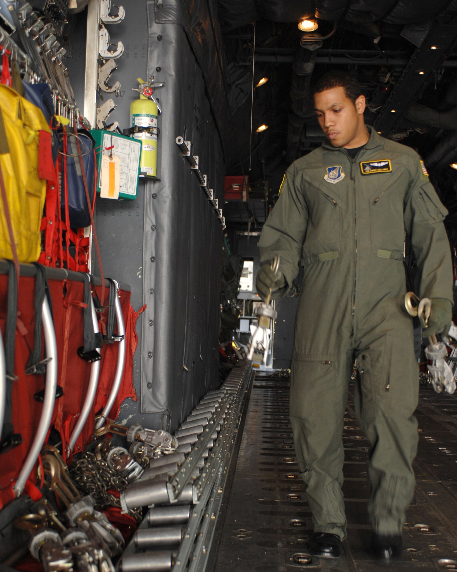 YOKOTA AIR BASE, Japan -- Senior Airman Andre Holloway, 36th Airlift Squadron, preps a C-130 Hercules for loading during a training exercise here March 12. (U.S. Air Force photo/Senior Airman Laszlo Babocsi)
