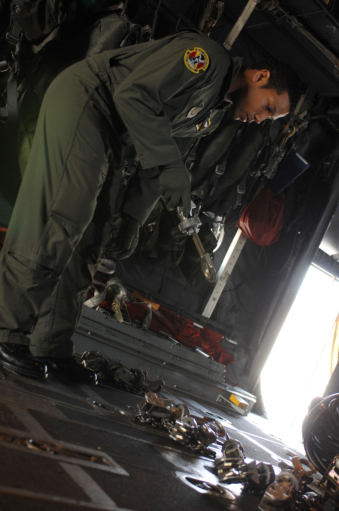 YOKOTA AIR BASE, Japan -- Senior Airman Andre Holloway, 36th Airlift Squadron, preps a C-130 Hercules for cargo loading during a training exercise here March 12. (Photo by Senior Airman Laszlo Babocsi)
