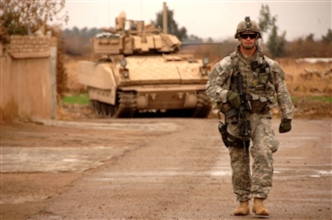 A U.S. Army soldier patrols on foot through a village southeast of Salman Pak, Iraq, on Feb. 15, 2008.  Soldiers from the 1st Battalion, 15th Infantry Regiment, 3rd Heavy Brigade Combat Team, 3rd Infantry Division, are working with residents of the village to improve security in their area.  