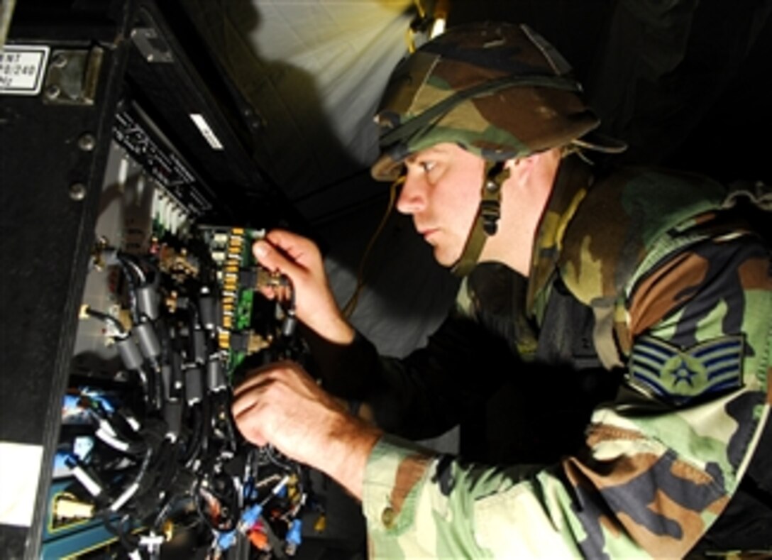 U.S. Air Force Staff Sgt. Eric Wentworth replaces a broken line card on a communication system inside the theater deployable communications tent during an operational readiness inspection on Kadena Air Base, Japan, March 11, 2008. Wentworth is assigned to the 18th Communications Squadron.
