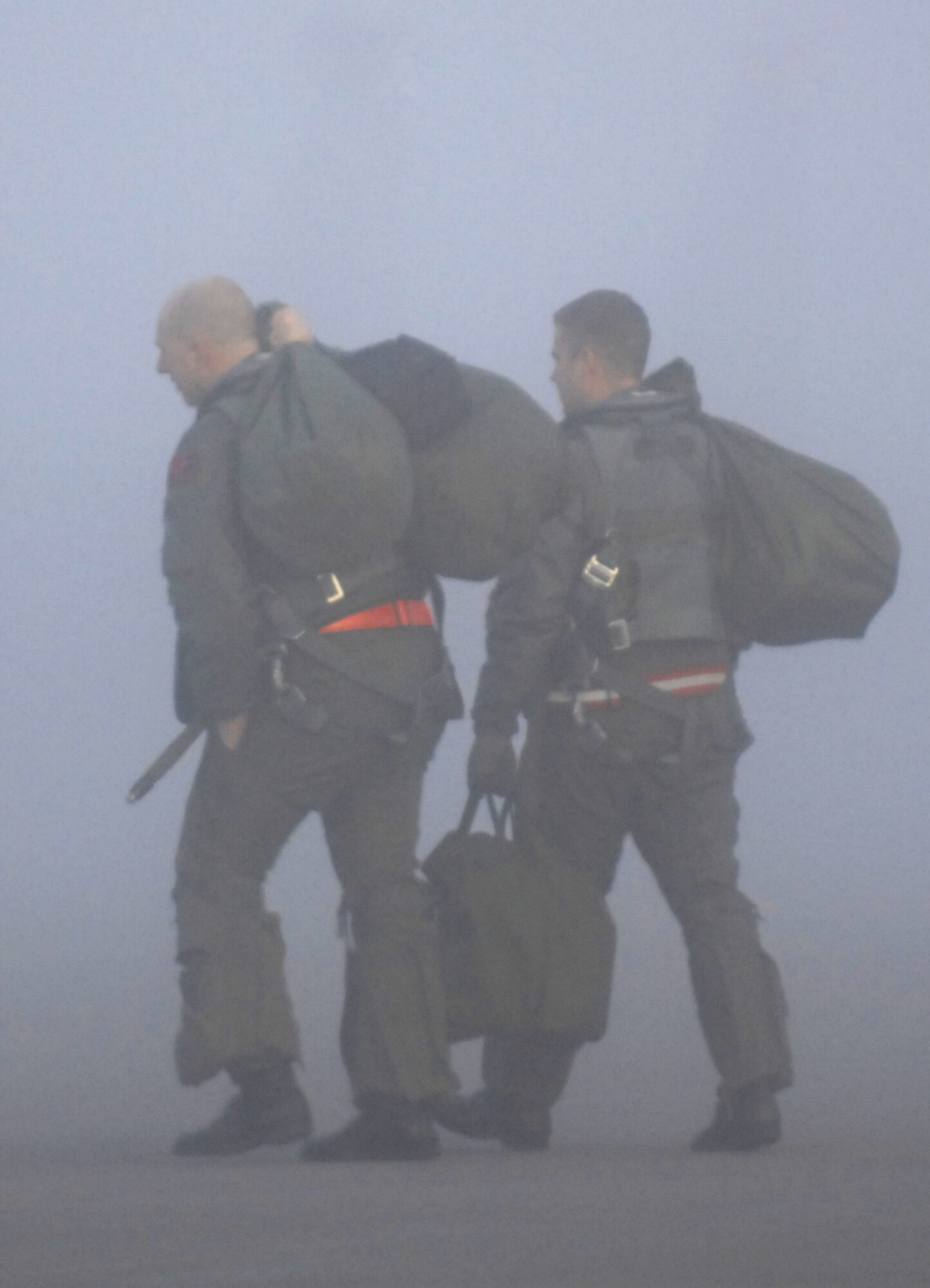 MOUNTAIN HOME AIR FORCE BASE, Idaho – A pilot and weapon systems officer from the 389th Fighter Squadron walk to their jet as a thick fog rolls in over the flightline during Exercise Coronet White 08-ACC-14 March 15. During the exercise, pilots and WSO's are required to fly a predetermined number of jets to a simulated deployed location. The 366th Fighter Wing is participating in an Operational Readiness Inspection March 13-21 to test the wing’s ability to deploy and take its mission to war. (U.S. Air Force photo/ Airman 1st Class Ryan Crane)