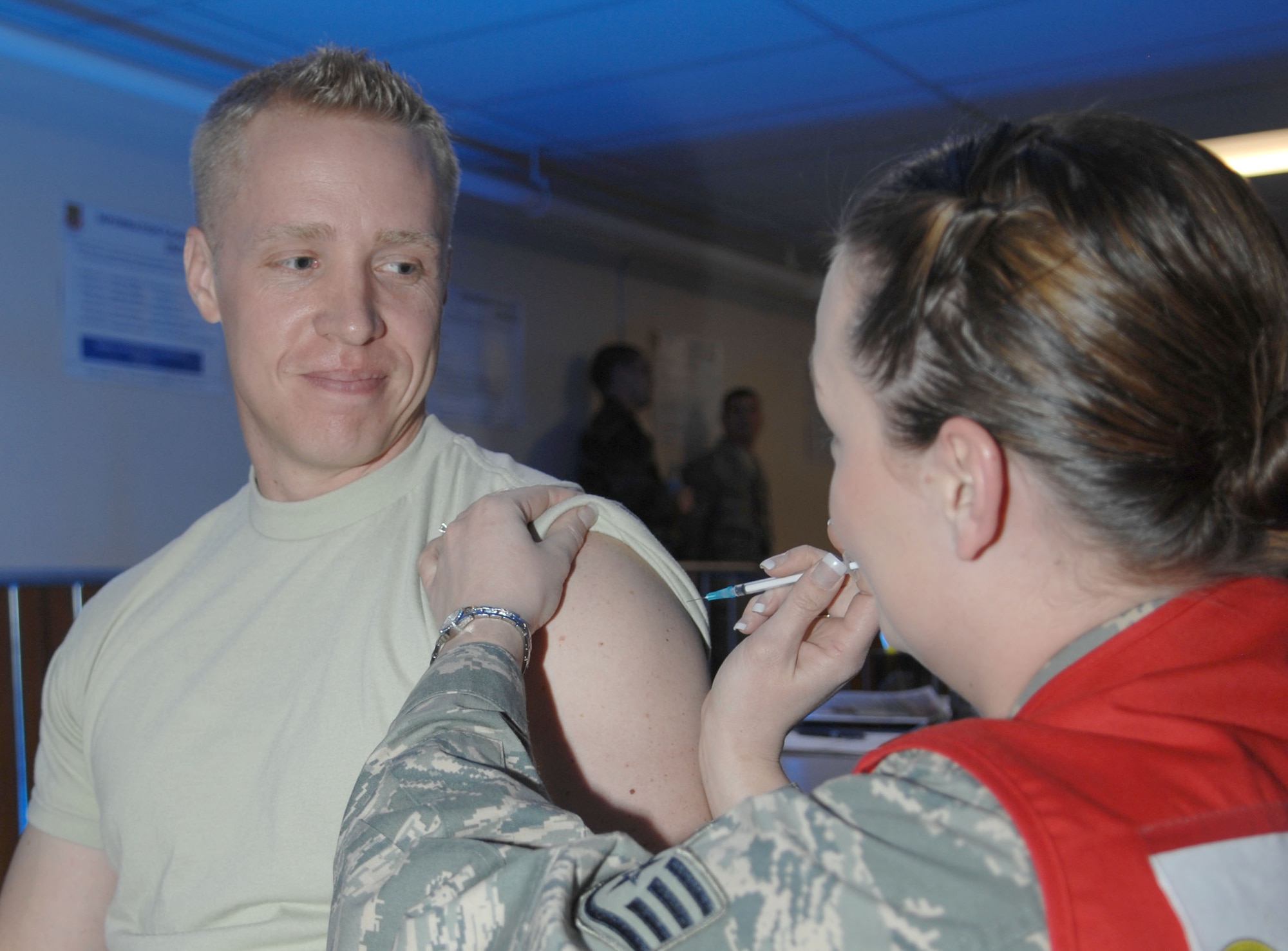 MOUNTAIN HOME AIR FORCE BASE, Idaho -- Staff Sgt. Christie Schlattweiler, 366th Medical Group immunizations specialist, prepares to give 1st Lt. Shawn Allen, 366th Medical Operations Squadron physicians assistant, a shot before he deploys during Exercise Coronet White 08-ACC-14  March 14. The 366th Fighter Wing is participating in an Operational Readiness Inspection March 13-21 to test the wing's ability to deploy and take its mission to war. (U.S. Air Force photo by Tech. Sgt. Carly S. Burke) 
