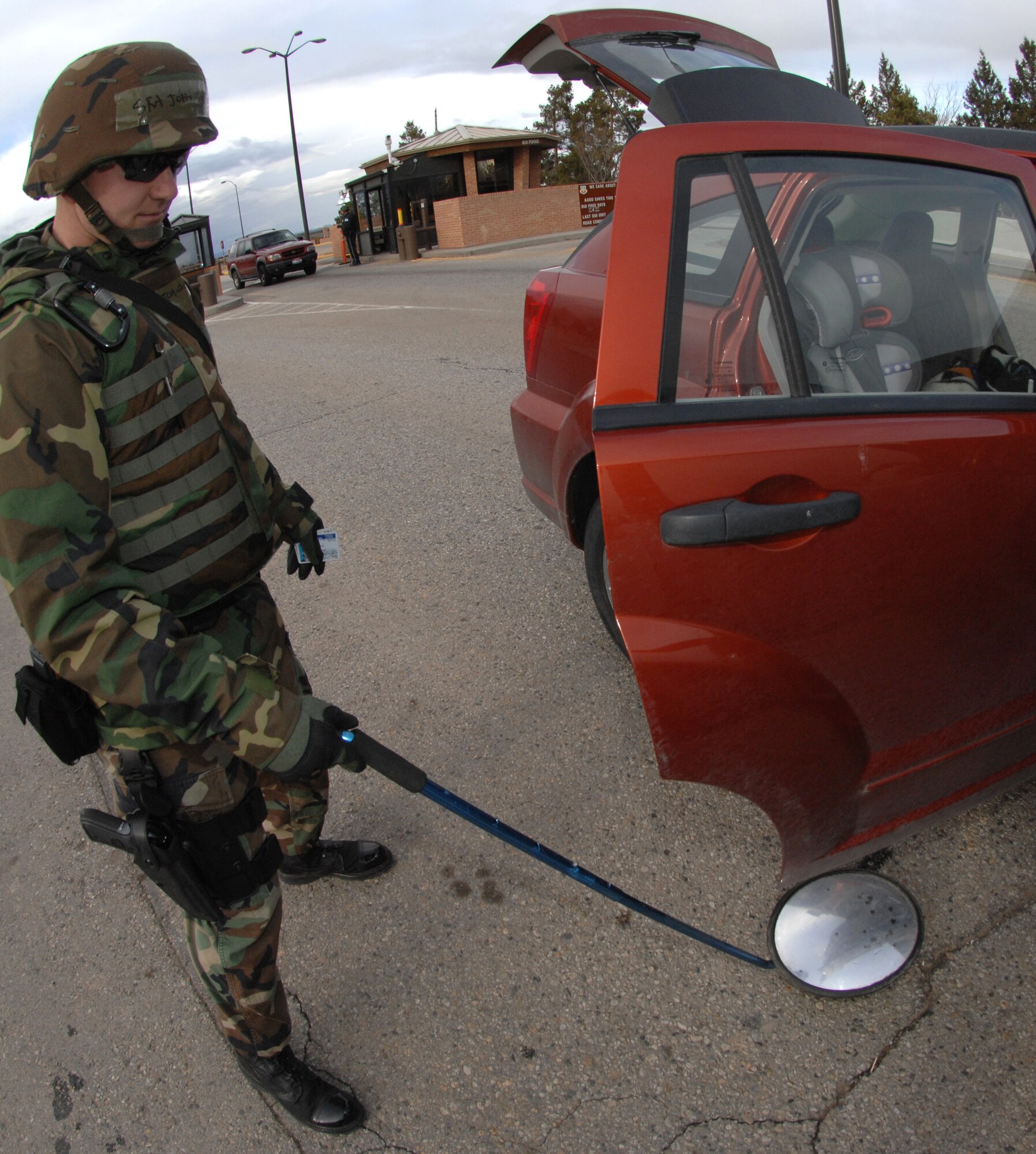 MOUNTAIN HOME AIR FORCE BASE, Idaho - Senior Airman Scott Johnson, 366th Security Forces Squadron patrolman, searches a car before it enters the base during Exercise Coronet White 08-ACC-14 March 14. The 366th Fighter Wing is participating in an Operational Readiness Inspection March 13-21 to test the wing's ability to deploy and take its mission to war. (U.S. Air Force photo/ Airman 1st Class Stephany Miller)