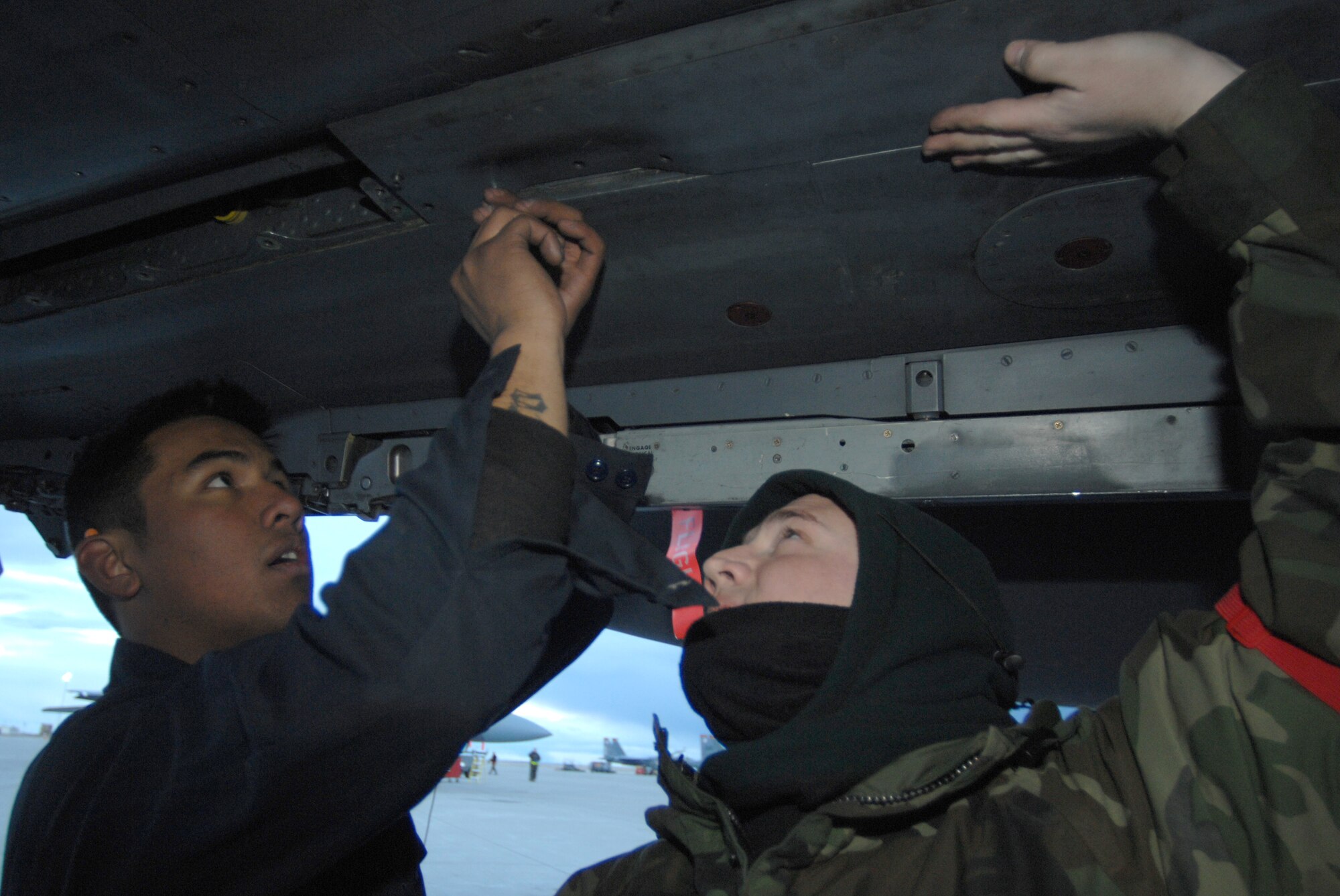 MOUNTAIN HOME AIR FORCE BASE, Idaho - Staff Sgt. Steven Gilbert and Airman 1st Class Alfredo Catolico, 389th Aircraft Maintenance Unit crew chiefs, install a conformal fuel tank to an F-15E Strike Eagle during Exercise Coronet White 08-ACC-14 March 14. The 366th Fighter Wing is participating in an Operational Readiness Inspection March 13-21 to test the wing's ability to deploy and take its mission to war. (U.S. Air Force photo/ Airman 1st Class Stephany Miller) 