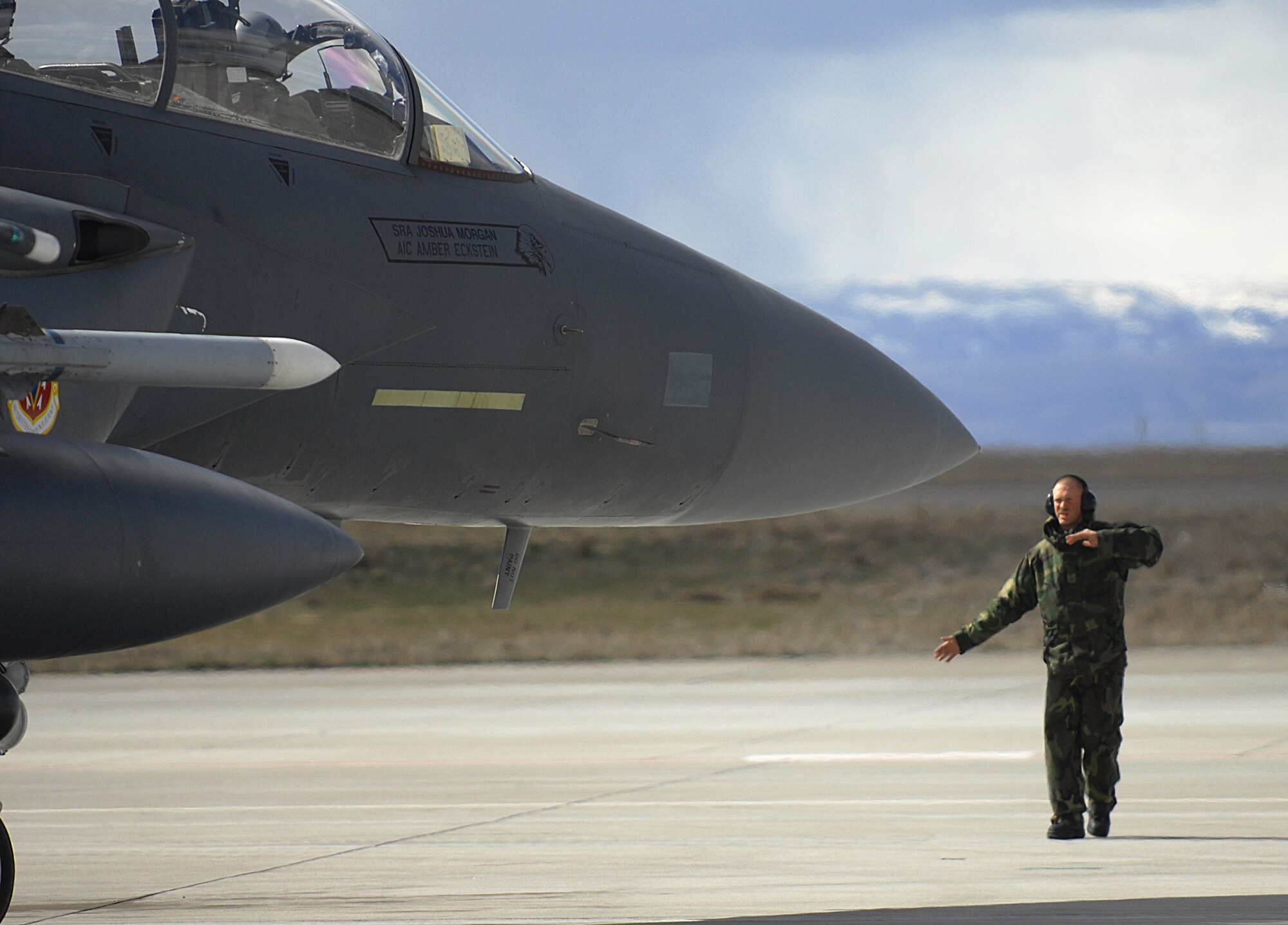 MOUNTAIN HOME AIR FORCE BASE, Idaho – Senior Airman Joshua Morgan, 391st Aircraft Maintenance Unit crew chief, directs the pilot of an F-15E Strike Eagle into position after they arrived at the simulated deployed location during Exercise Coronet White 08-ACC-14 March 15. During the Phase I portion of the exercise, the 366th Maintenance Group is required to generate a predetermined number of jets and successfully deploy downrange. The 366th Fighter Wing is participating in an Operational Readiness Inspection March 13-21 to test the wing’s ability to deploy and take its mission to war. (U.S. Air Force photo/ Airman 1st Class Ryan Crane) 