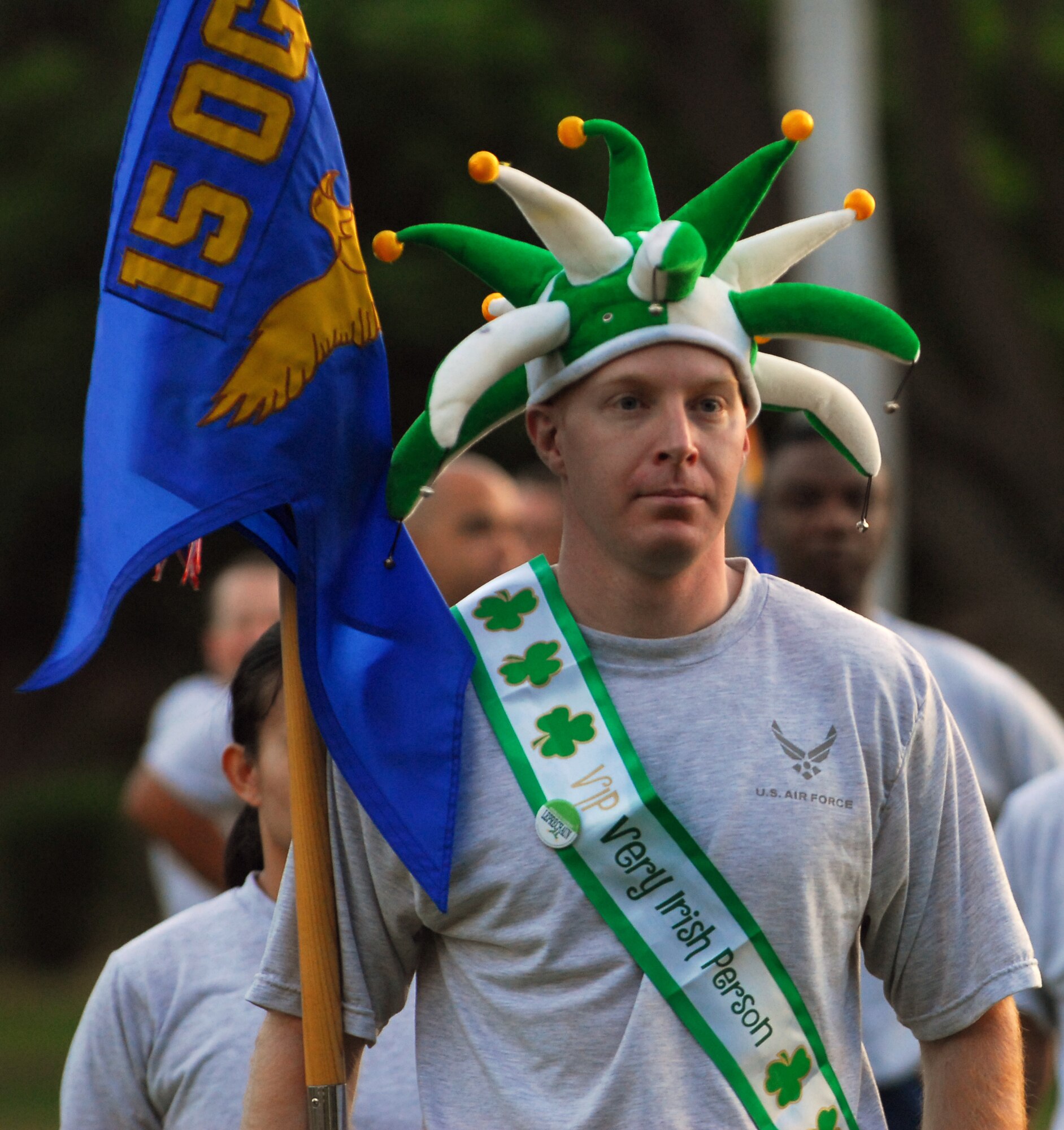 The "Very Irish Person" holding the 15th Operations Group Guidon is Tech. Sgt Terrance Murphy from the 15th Operations Support Squadron.  Sergeant Murphy, is part Irish and decided to show his support for St. Patrick’s Day during this month’s 15th Airlift Wing Warrior Run, March 7 by donning a cheerful hat and a VIP ribbon. (Photo by Master Sgt. Robert Burgess).