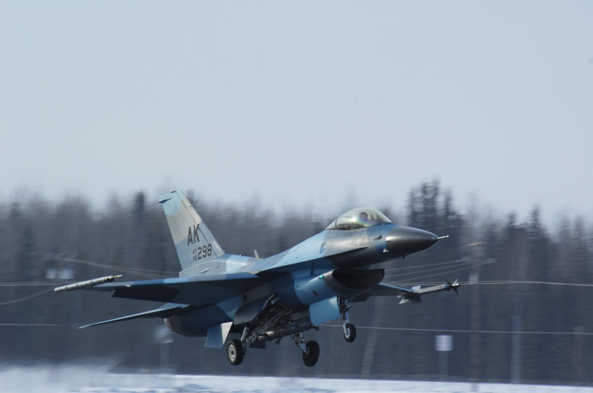 An F-16 Fighting Falcon 'Aggressor' with flanker color scheme takes off at Eielson Air Force Base, Alaska for a training mission over the Pacific Alaska Range Complex March 17. The 18th Aggressor Squadron's F-16 fly as the opposing force during Red Flag-Alaska exercises using enemy tactics, techniques and procedures to give a realistic simulation of aerial combat. (U.S. Air Force photo by Airman 1st Class Christopher Griffin)