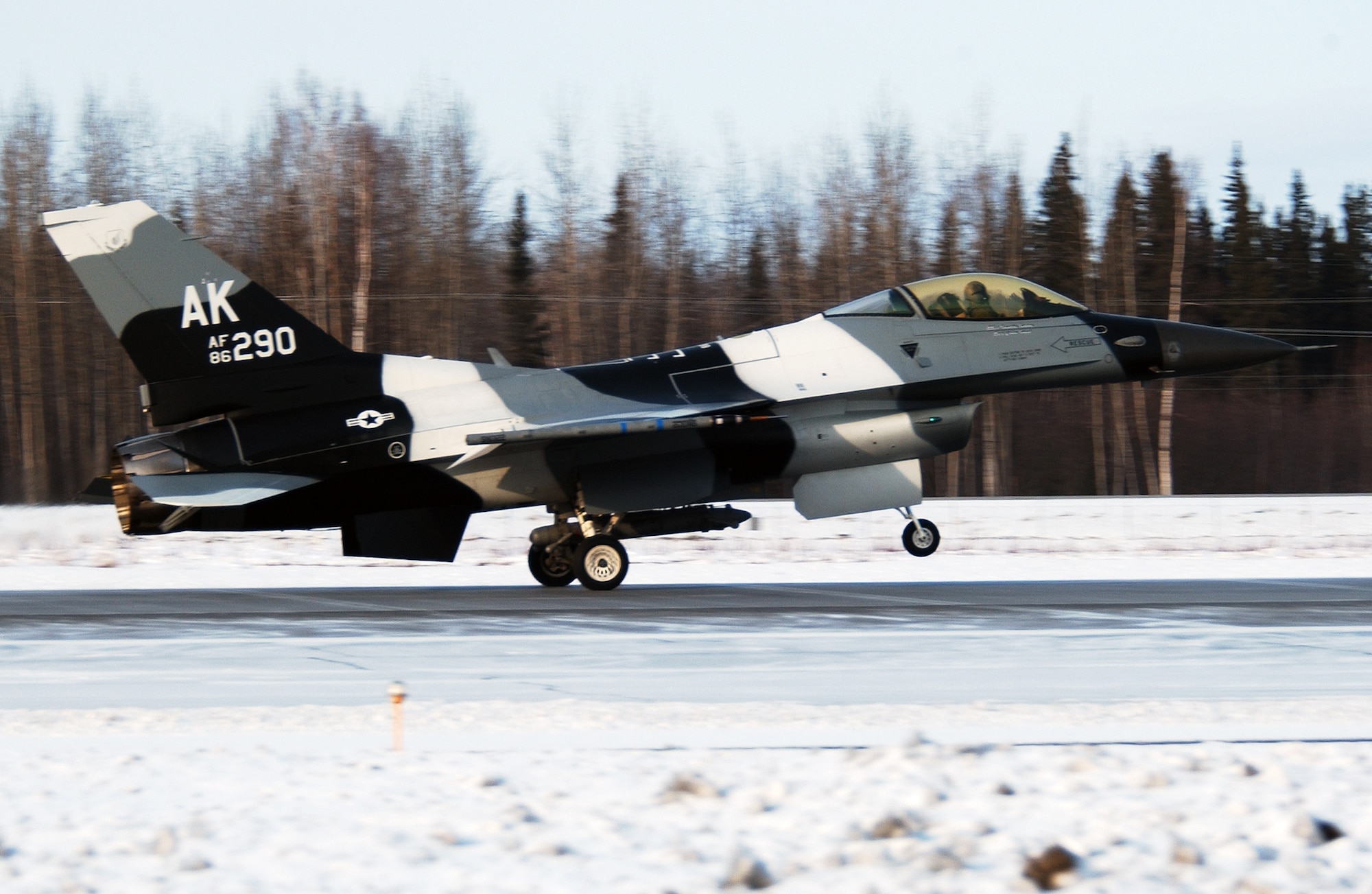An F-16 Fighting Falcon 'Aggressor' with arctic color scheme lands at Eielson Air Force Base, Alaska after flying a training mission over the Pacific Alaska Range Complex March 17. The 18th Aggressor Squadron's F-16 fly as the opposing force during Red Flag-Alaska exercises using enemy tactics, techniques and procedures to give a realistic simulation of aerial combat. (U.S. Air Force Photo/Airman 1st Class Jonathan Snyder)