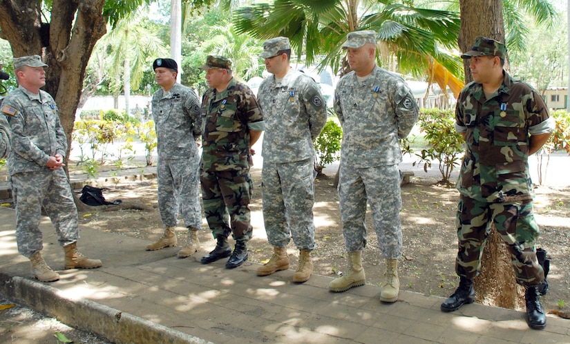 Army Lt. Col. Rob Gaddis, Nicaragua Military Group commander, thanks co-workers (from left) Army Lt. Col. Luis Utrevas, Navy Cmdr. Angel Oliveras, Army Capt. Gilberto Ruiz, Army Staff Sgt. Roberto Ruiz and Navy and Petty Officer 2nd Class Lenin Sanchez after they received the Humanitarian Service Medal for their performance during Hurricane Felix in September, 2007. (U.S. Air Force photo by Tech. Sgt. William Farrow)
