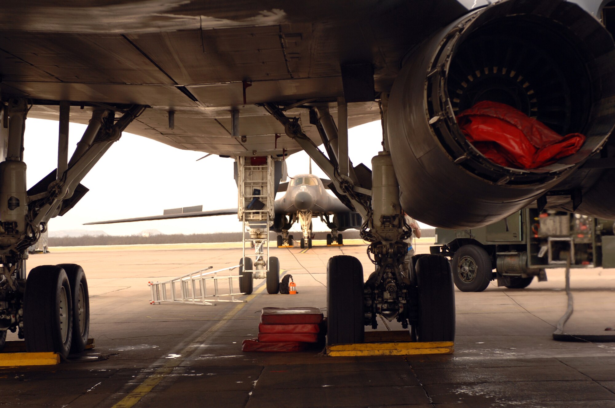 DYESS AIR FORCE BASE, Texas -- A B-1 Bomber gets fueled with a 50/50 blend of synthetic and petroleum fuel as another B-1 Bomber sits in the distance, March 17. The B-1 Bomber is the Air Force's first aircraft to fly at supersonic speed using the fuel blend. (U.S. Air Force photo by SrA Courtney Richardson)